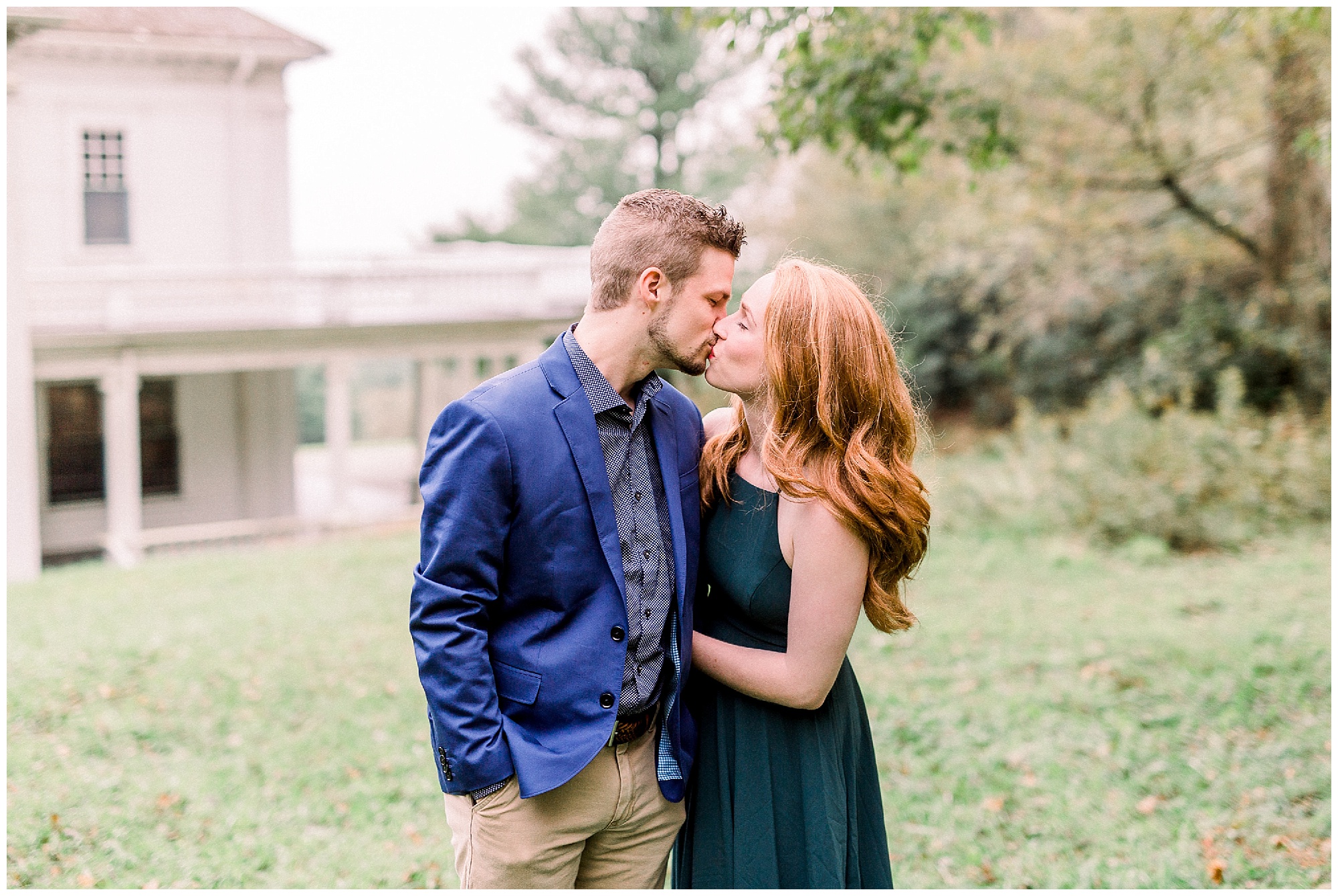couple kisses during Boone NC engagement session at Moses Cone Manor