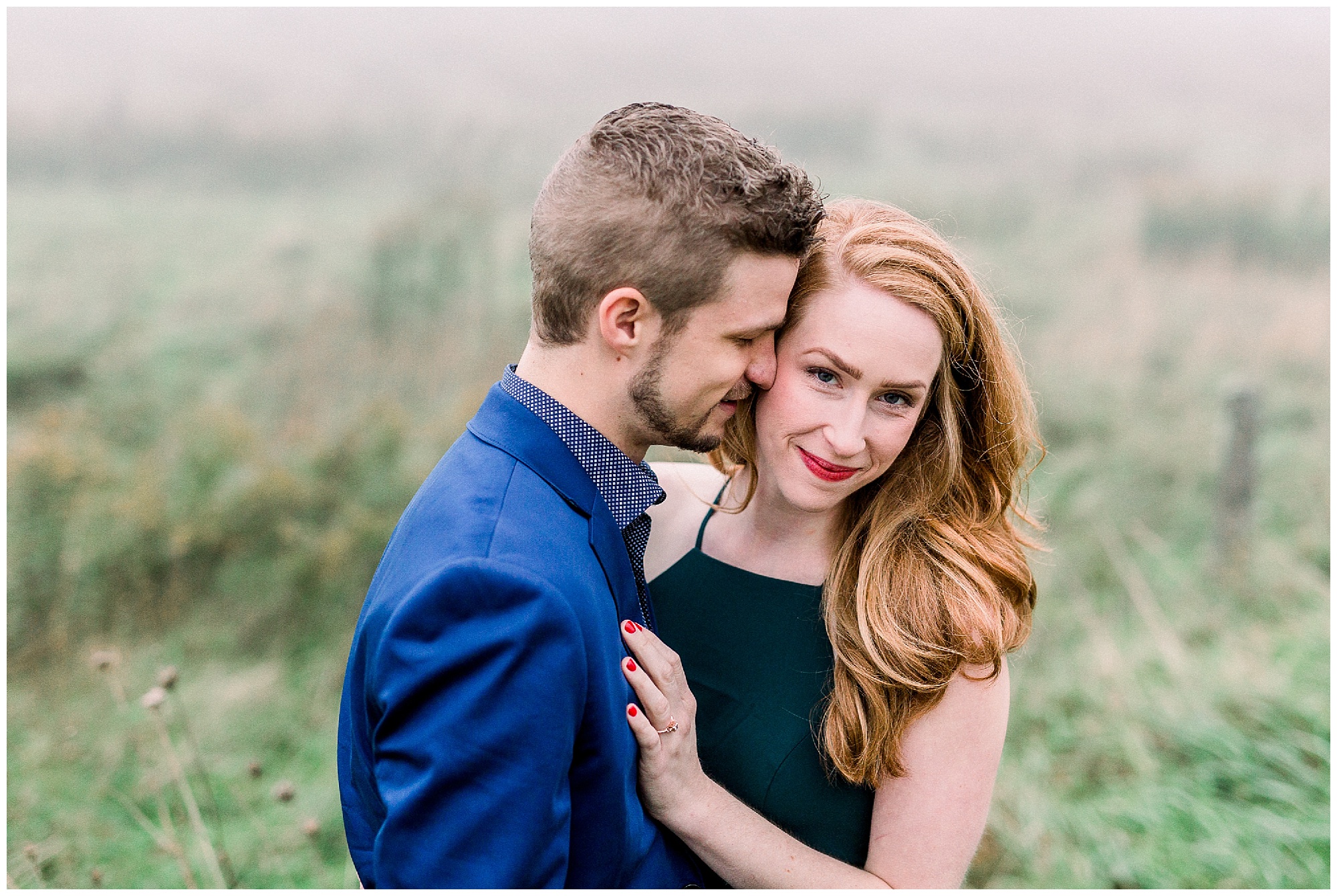 groom nuzzles bride's forehead during foggy mountain engagement session