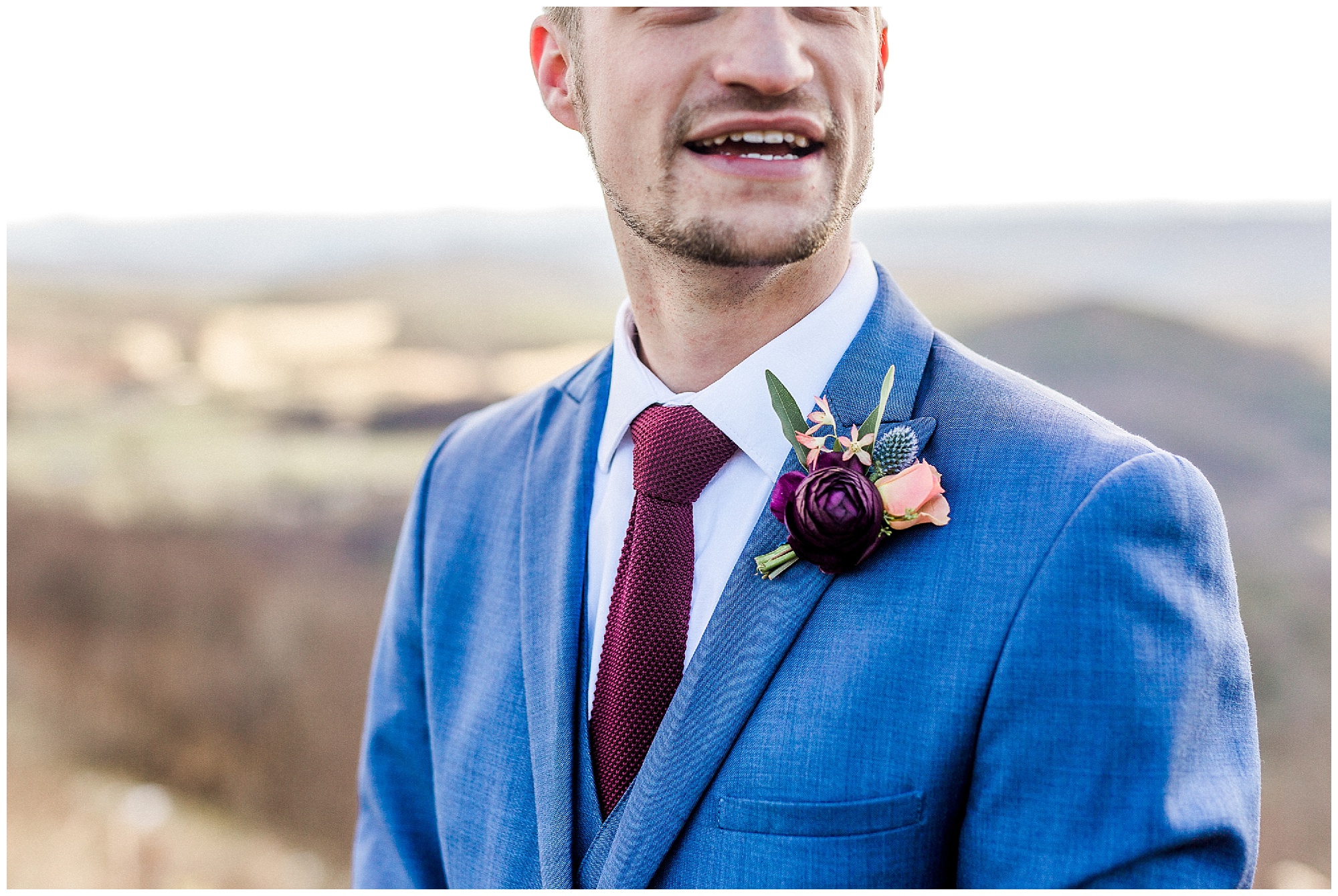 groom in navy suit with winter boutonniere before Sky Retreat wedding