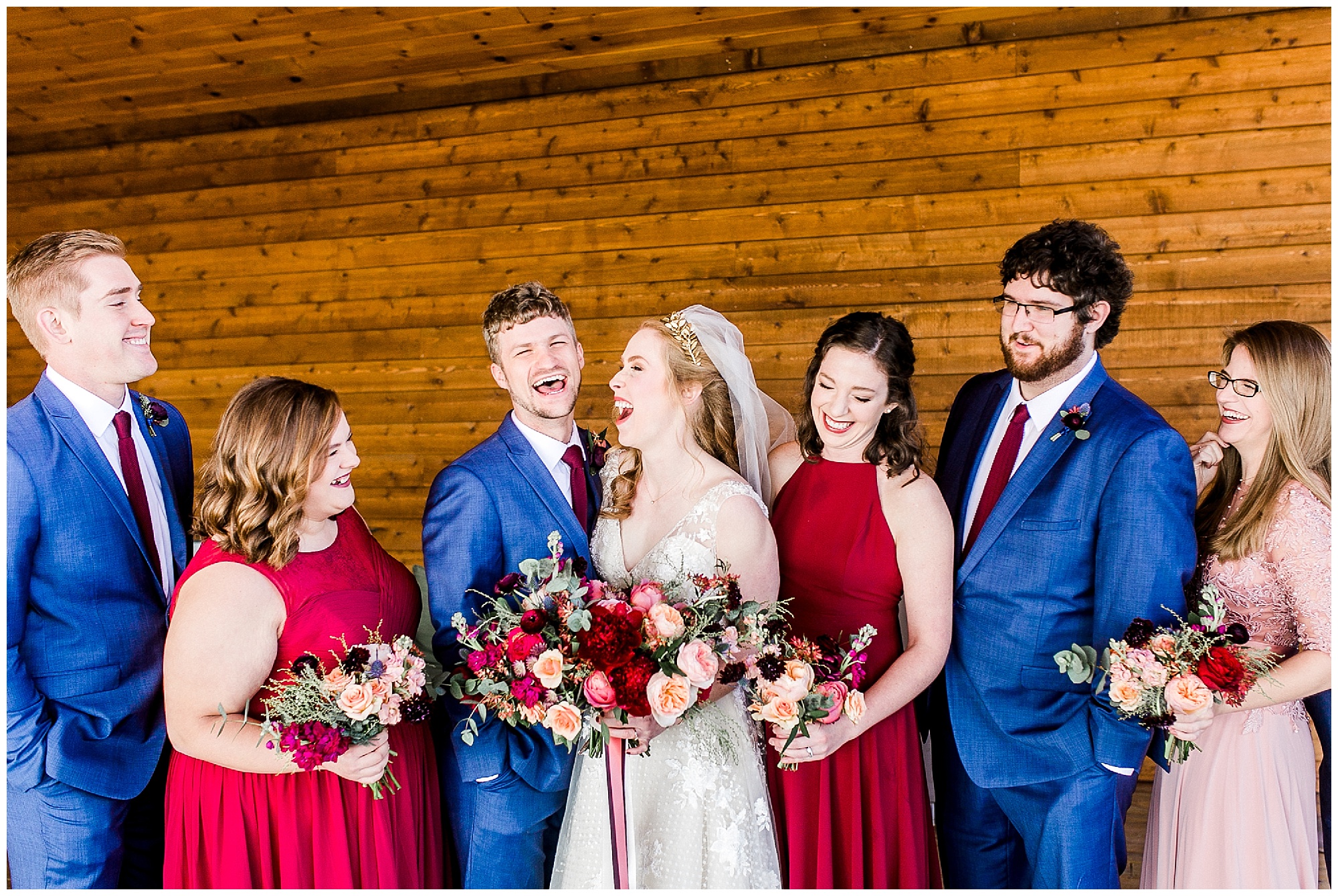 newlyweds laugh with bridal party during Sky Retreat wedding photos