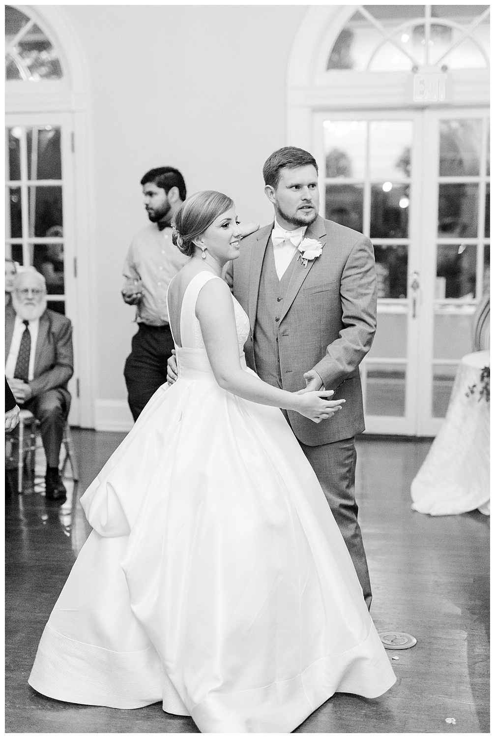a bride and groom share a first dance at their wedding reception