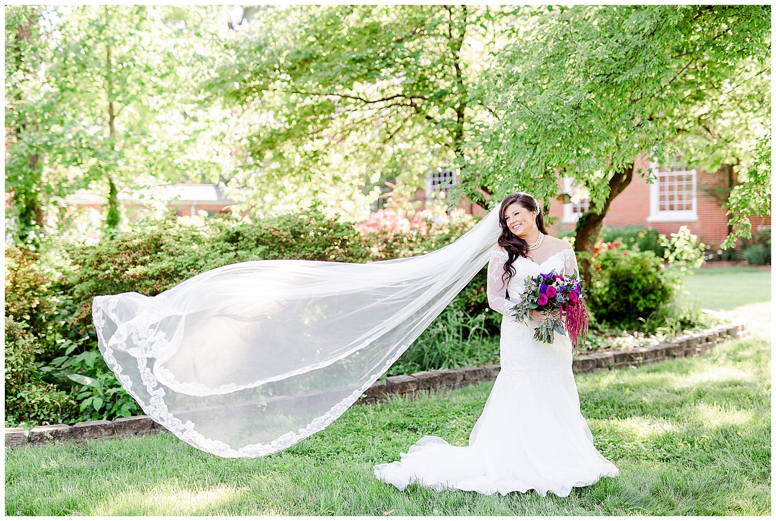 💍 bridal shot of bride and veil flying in wedding portrait photo with lace wedding dress with rhinestone belt rhinestone barrette in hair down with pearls 💍 Bright Colorful Summer City Wedding in Charlotte, NC with Taryn and Ryan | Kevyn Dixon Photography