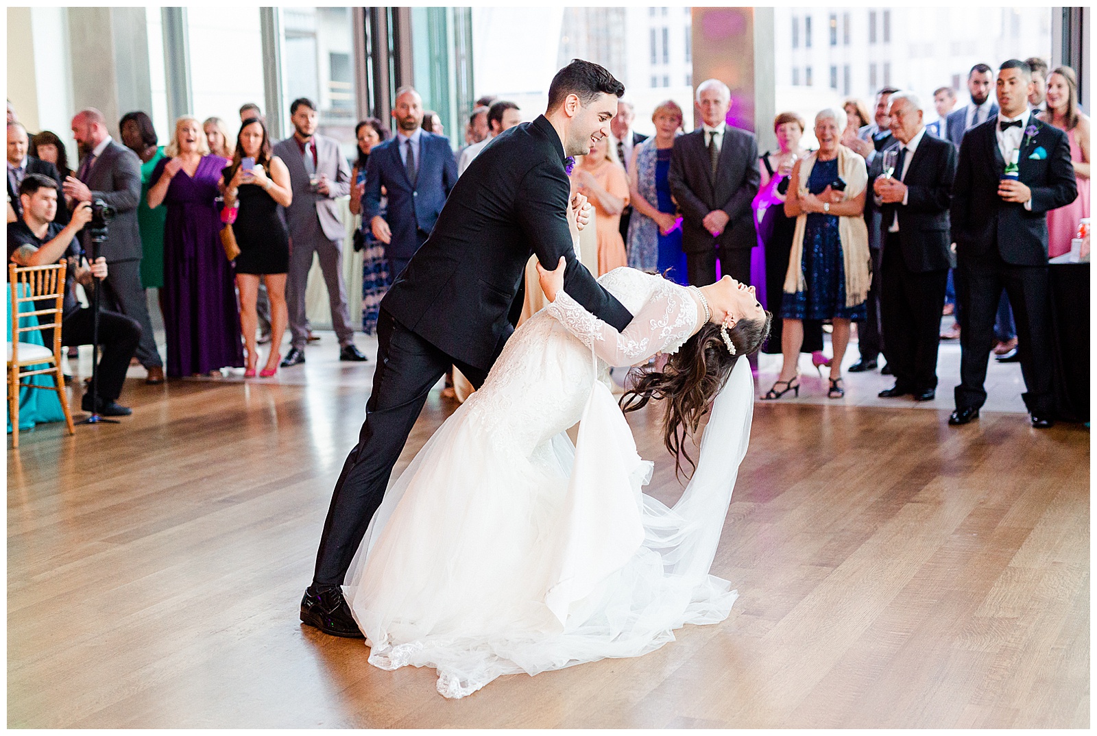 💍 bride groom first dance indoor wedding reception 👰 Bride: lace wedding dress with rhinestone belt rhinestone barrette in hair down with pearls 🤵 Groom: black tux tuxedo and purple flower boutonnière 💍 Bright Colorful Summer City Wedding in Charlotte, NC with Taryn and Ryan | Kevyn Dixon Photography