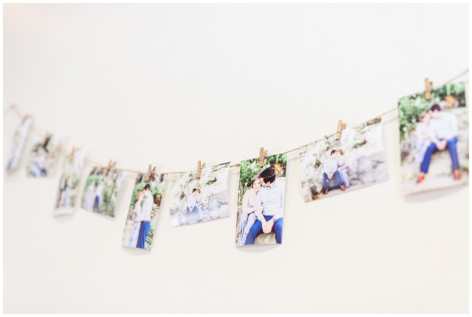 Indoor Wedding Decor idea of Engagement Photos hanging on twine from Outdoorsy Summer Wedding at North Carolina Lakehouse in the Mountains | check out the full wedding at KevynDixonPhoto.com