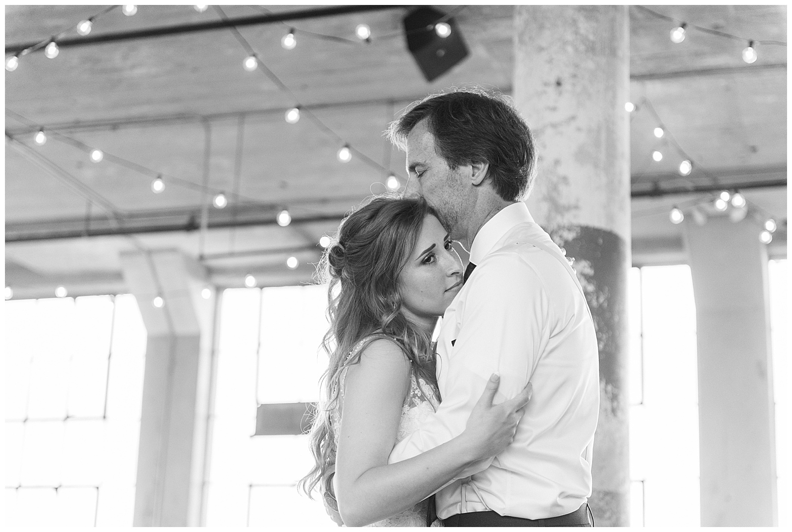 Emotional Bride and Dad Father-Daughter dance at Rustic Airy Indoor Wedding Venue with fairy lights in Elegant Modern Summer Wedding in Charlotte, NC | check out the full wedding at KevynDixonPhoto.com