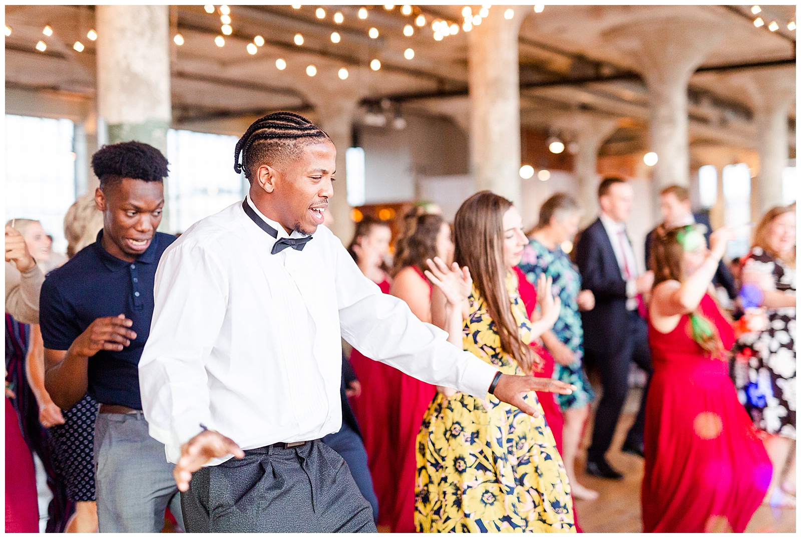 Join the dance party at Rustic Airy Indoor Wedding Venue with fairy lights - Red-Themed Bridesmaid Dress Ideas from Elegant Modern Summer Wedding in Charlotte, NC | check out the full wedding at KevynDixonPhoto.com