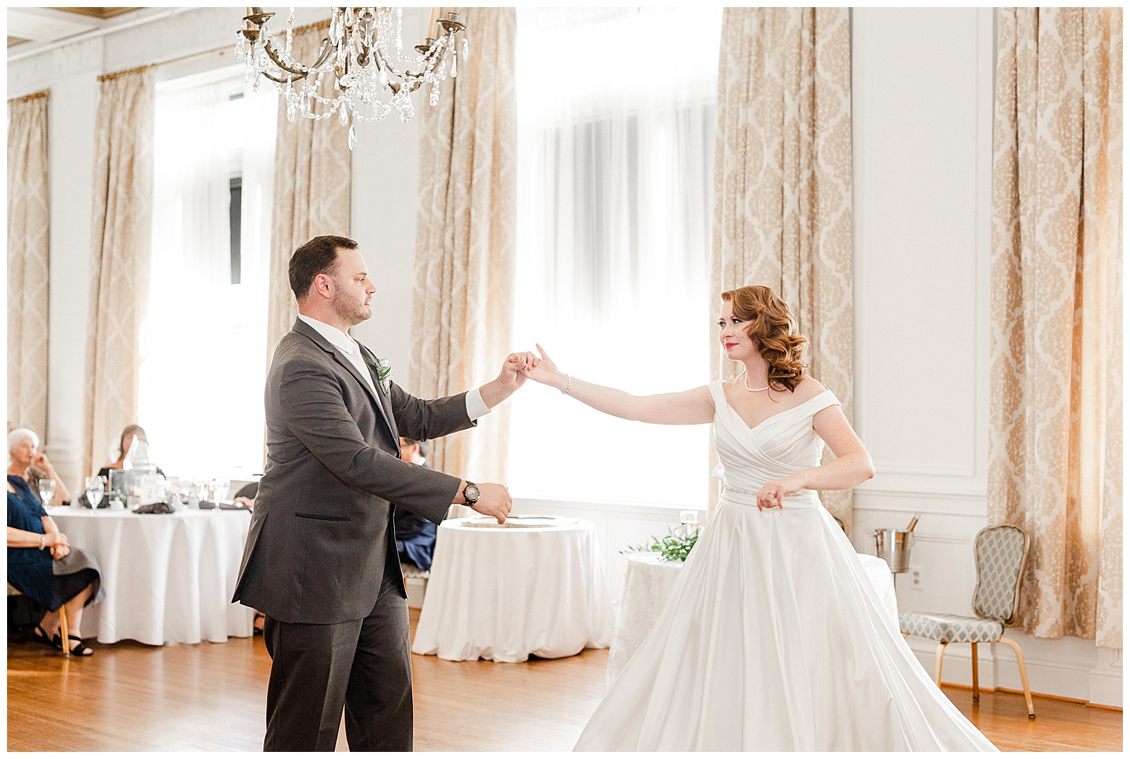 Gorgeous Red-Haired Bride and Groom’s First Dance at elegant indoor floral venue in 1940s Modern Vintage Wedding in Charlotte, NC | check out the full wedding at KevynDixonPhoto.com