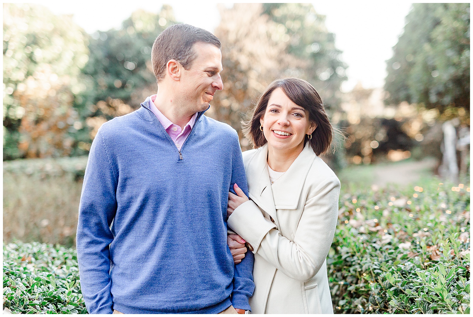 Sweet Couple Laughing in Park at Outdoor Winter Engagement Session in NC - white coat, short brown hair bride outfit ideas