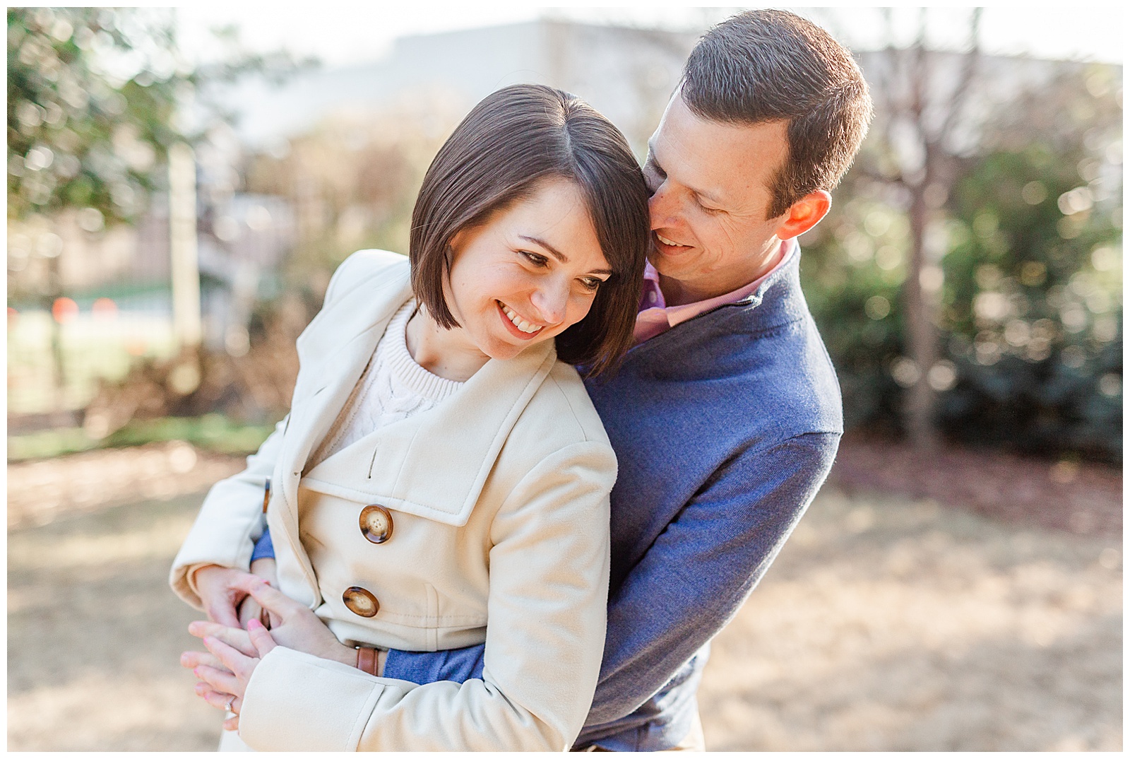 Sweet Couple in Park at Outdoor Winter Golden Hour Engagement Session in NC - white coat, short brown hair bride outfit ideas