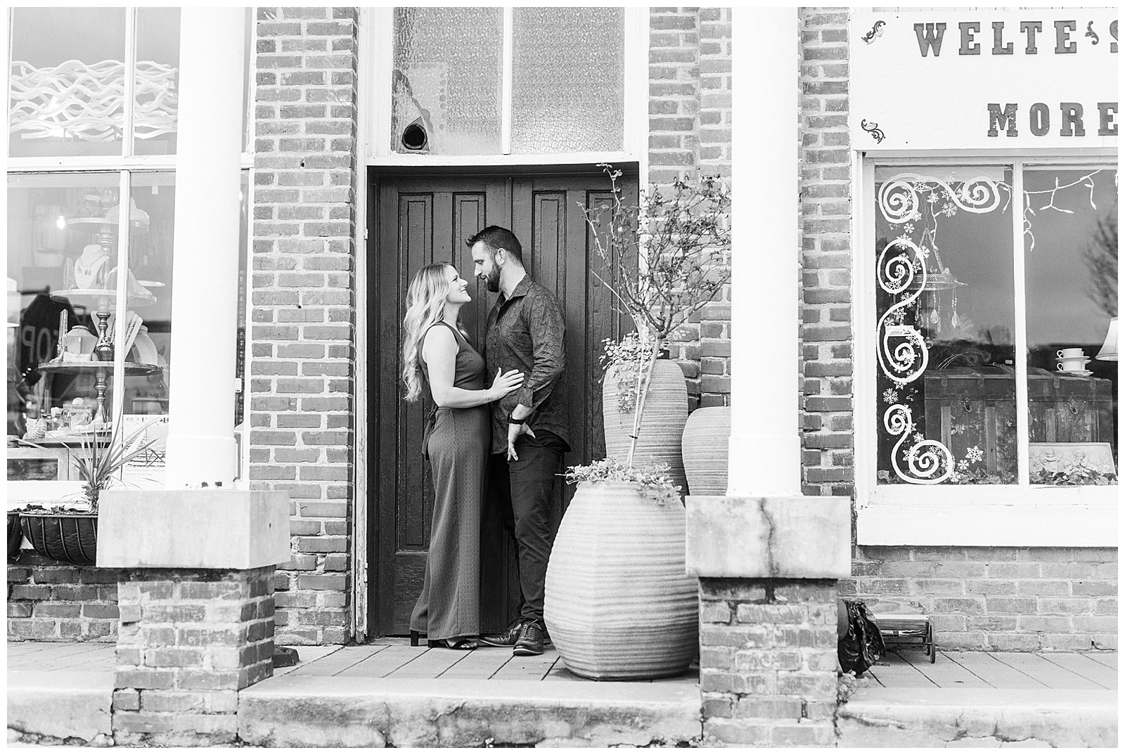 Adorable couple in front of royal blue door in downtown Waxhaw, NC Engagement Session with Green Dress Outfit Ideas