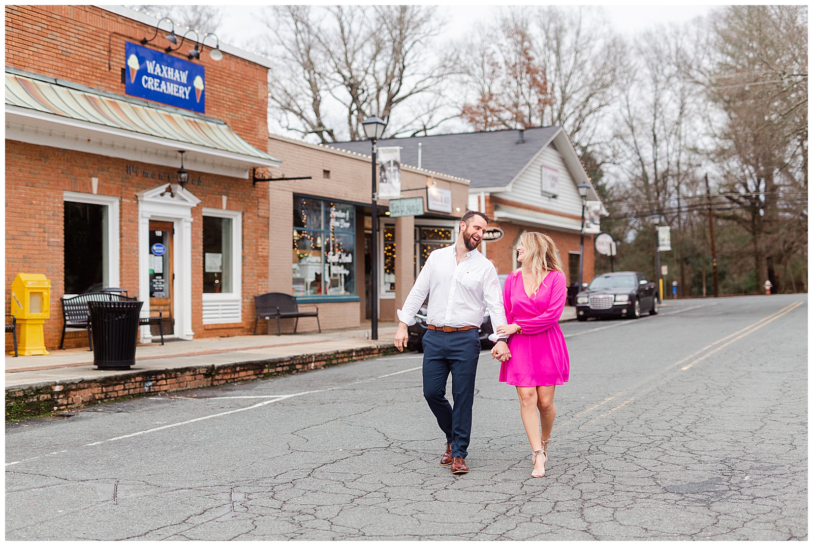 Adorable couple walking down main street in downtown Waxhaw, NC Engagement Session with Bright Hot Pink Dress Outfit Ideas