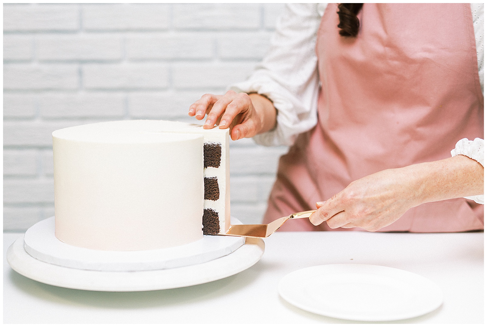 Charlotte NC Wedding Cake Designer Aryn Keogh Cutting Chocolate Cake