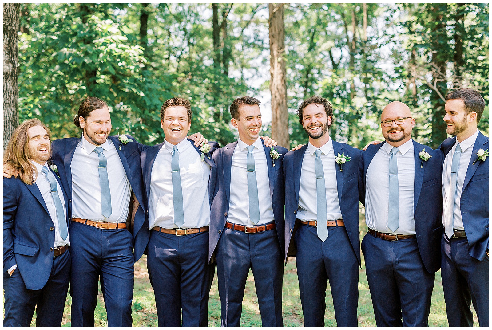 navy blue suits for groomsmen group photos laughing outdoors