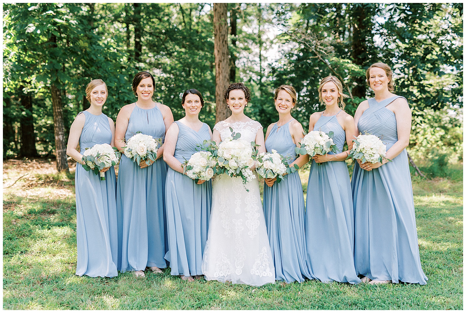 dusty blue bridesmaid bride tribe with white flower bouquet summer outdoor group photo