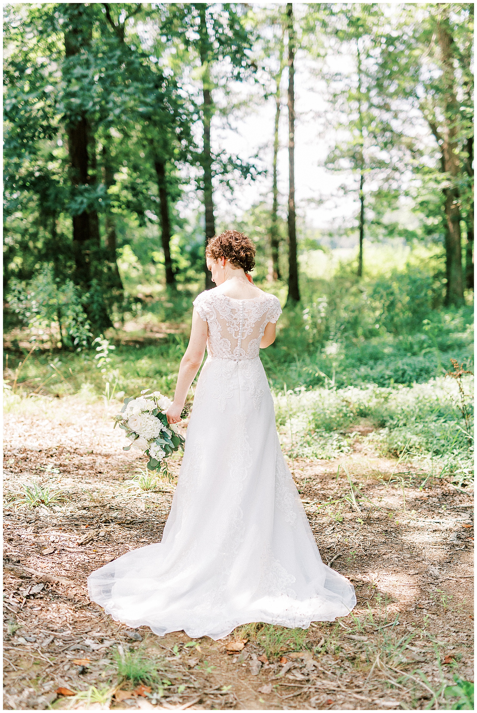 curly short haired bride with lace wedding dress outdoor summer bridal wedding day portraits with white bouquet