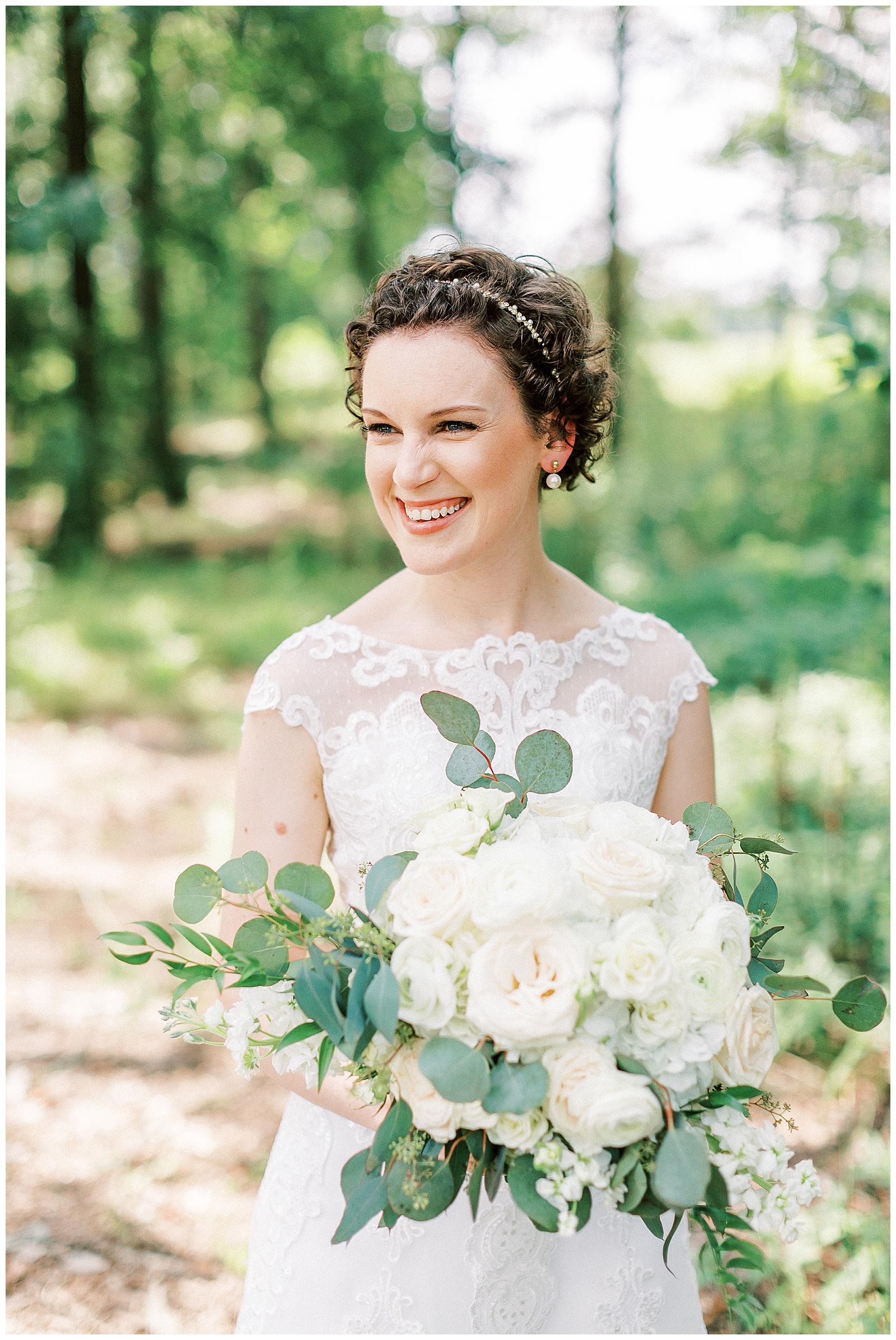 curly short haired bride with lace wedding dress outdoor summer bridal wedding day portraits with white bouquet
