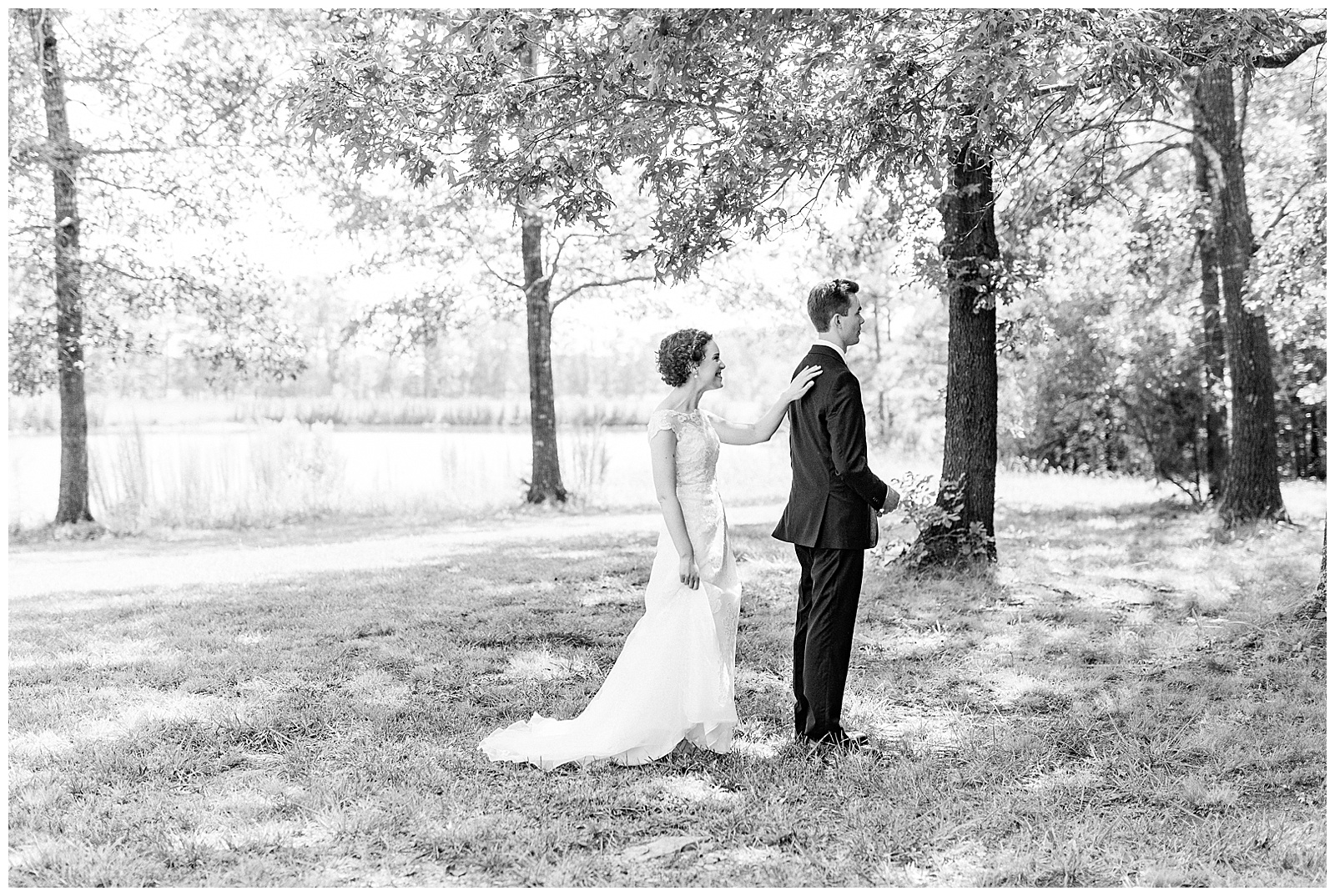 outside groomsmen first look of curly short haired bride with lace wedding dress