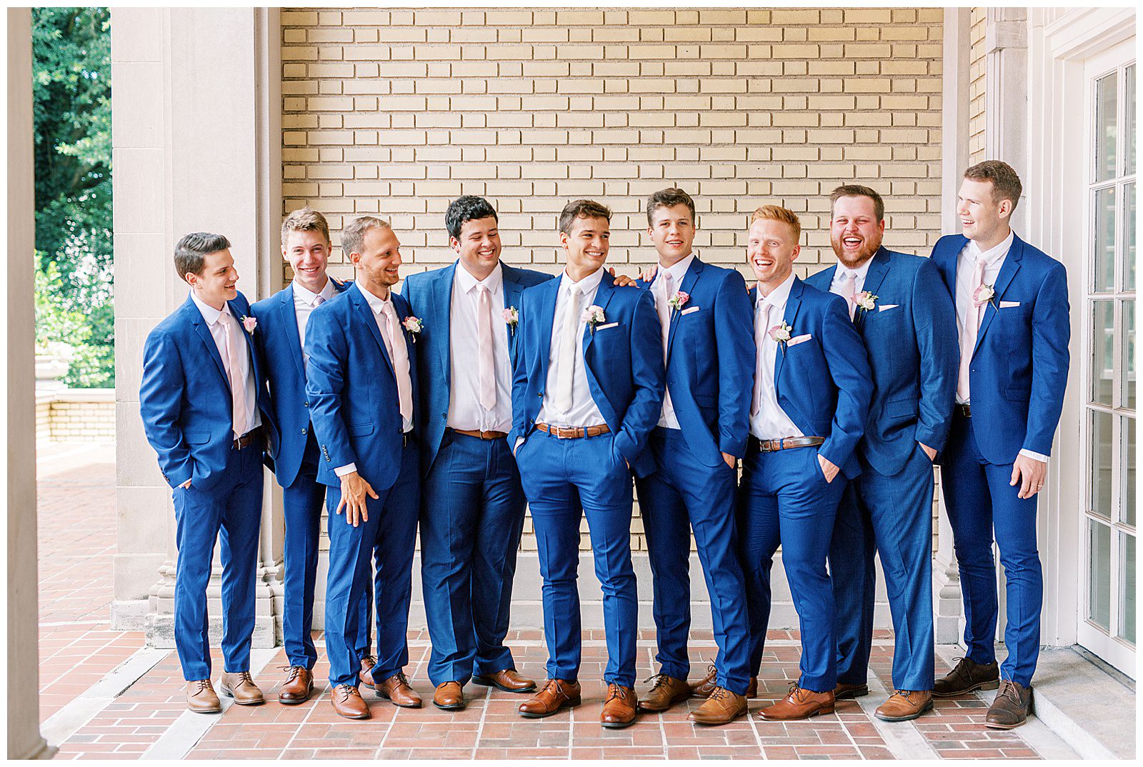dapper navy royal blue groomsmen style with pink ties outdoor guys group portrait