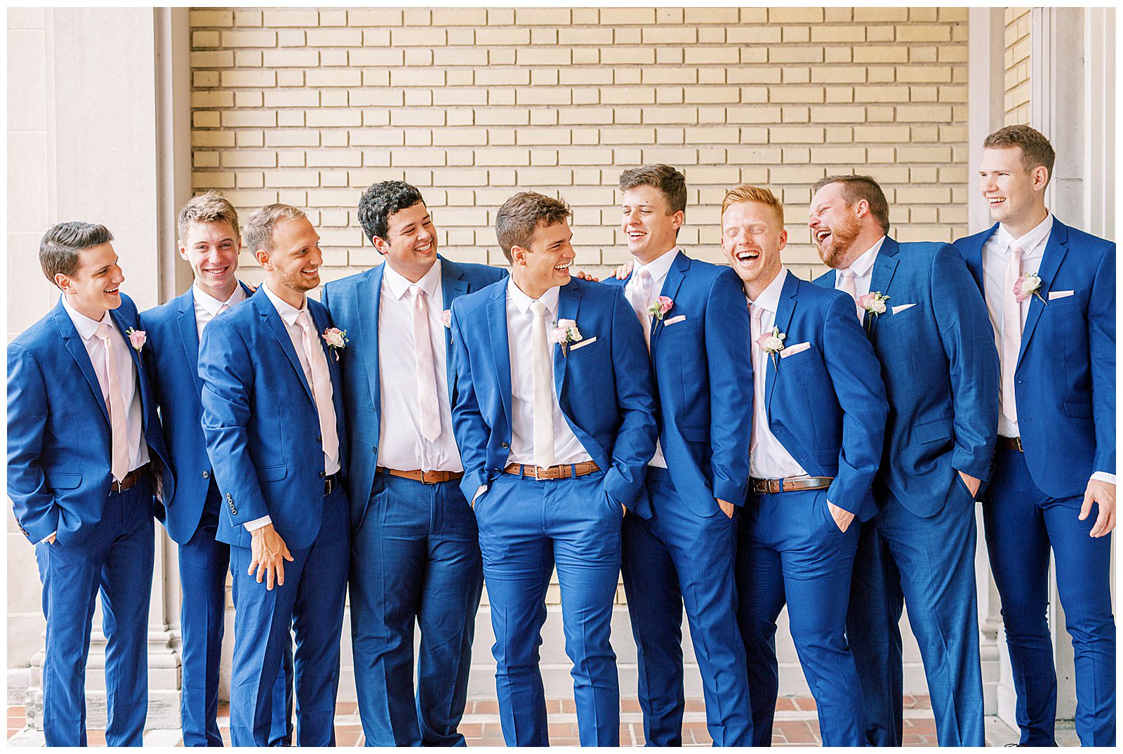 dapper navy royal blue groomsmen style with pink ties outdoor guys group portrait