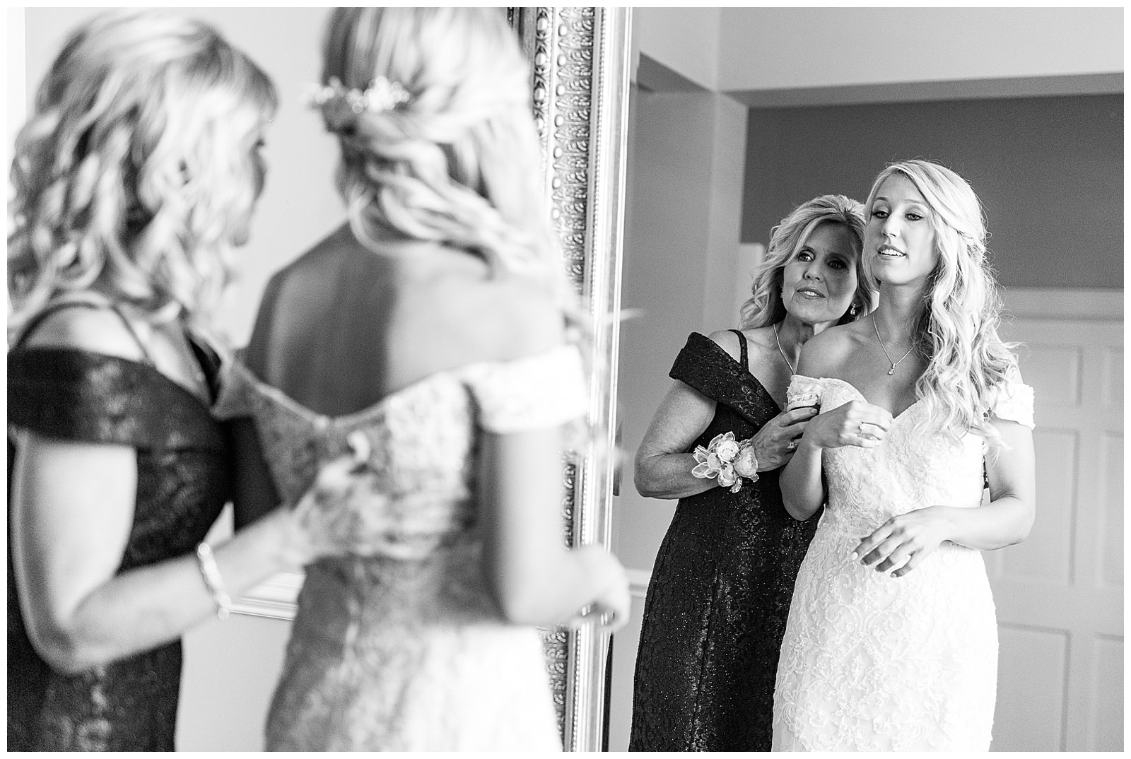 blonde haired bride getting into lace wedding dress in separk mansion bridal suite getting ready room