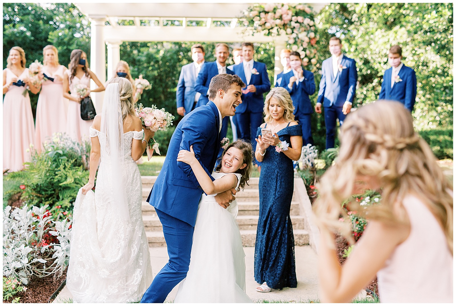 summer wedding toast outdoors at separk mansion with navy royal blue and soft pink bridal party