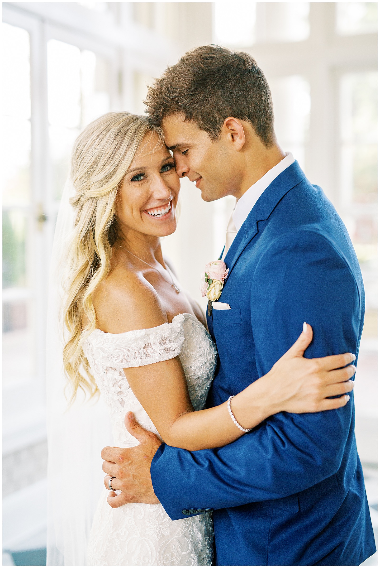 blond haired bride and dapper navy royal blue groom portraits in separk mansion black and white ballroom
