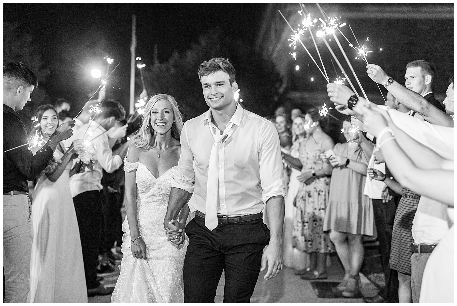 bride and groom sparkler exit at esquire hotel outdoor patio wedding reception