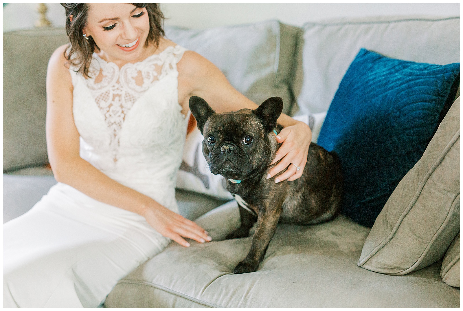 bride in lace wedding dress petting cute pug dog