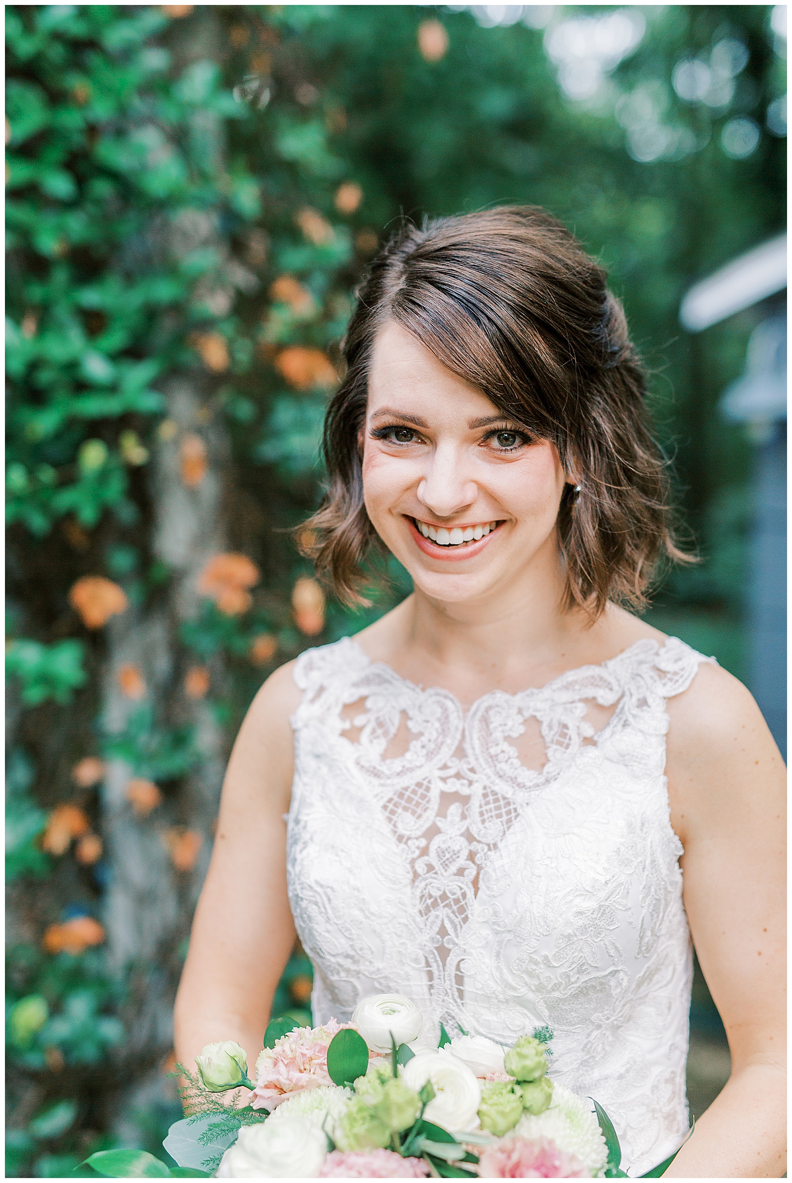 outdoor summer bridal portraits of short brown haired bride in lace dress with long train