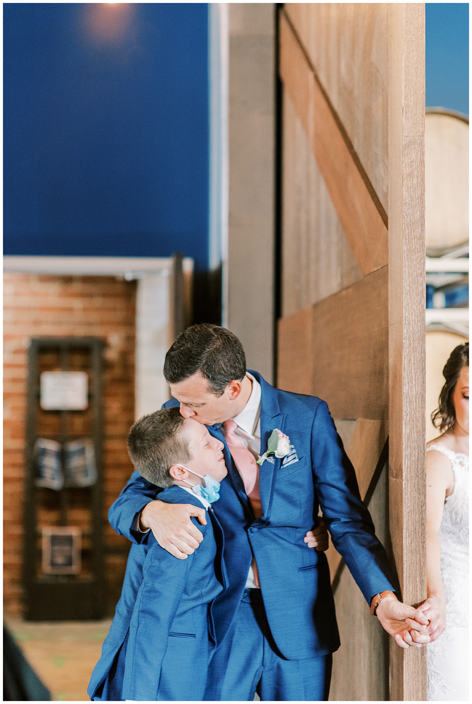 emotional bride groom first touch indoor with son of groom