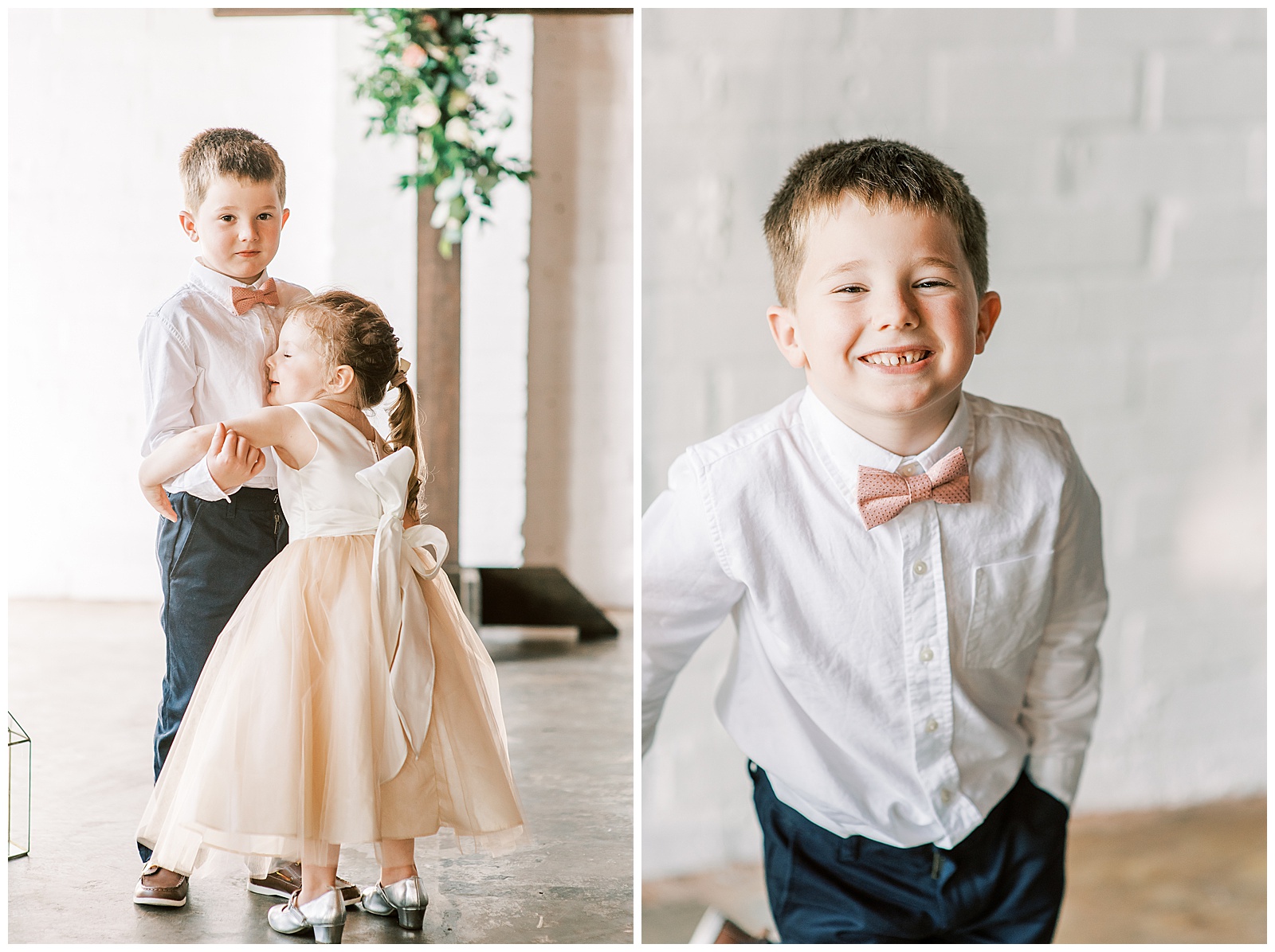 adorable blonde haired flower girl in fluffy tulle dress hugs cute ring bearer with pink bowtie against white wall