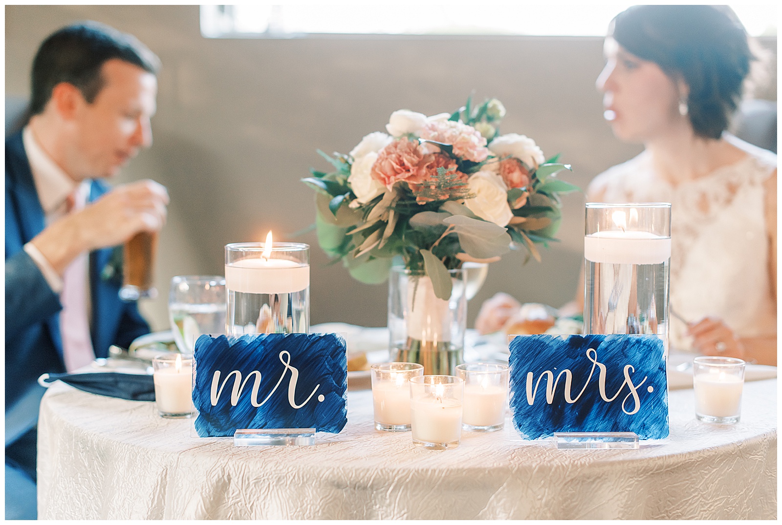 bride and groom mr and mrs table sign in stunning modern catering space with fairy lights
