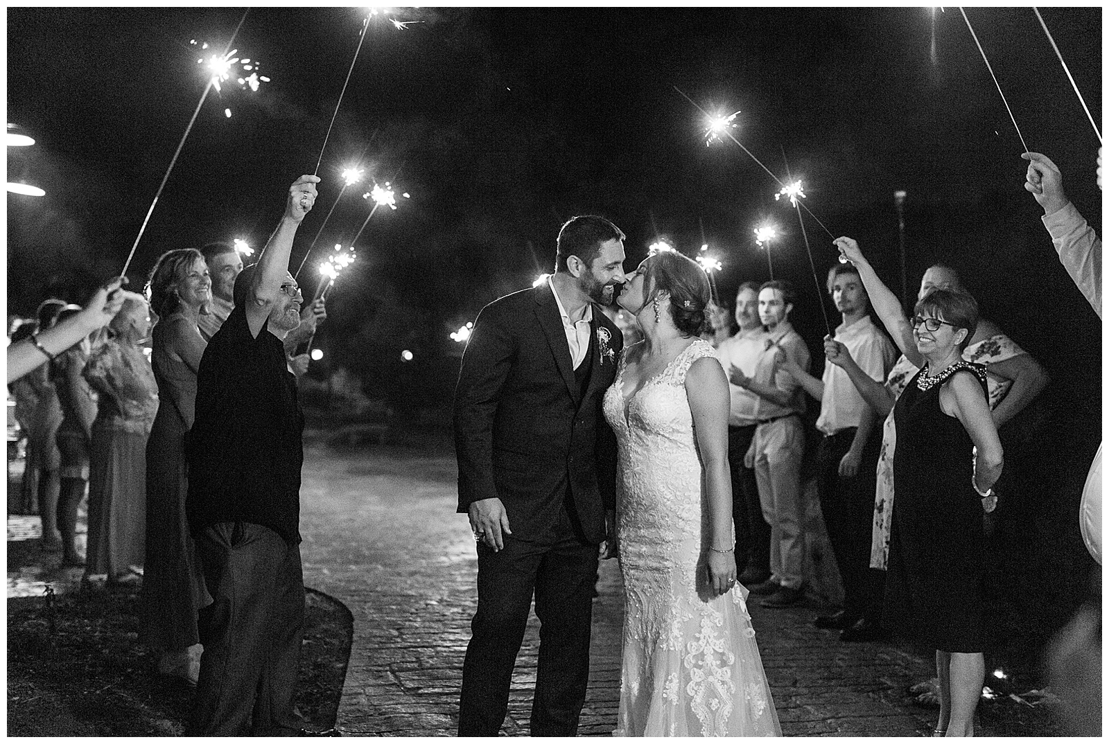 bride and groom kiss at sparkler exit at indoor outdoor summer wedding