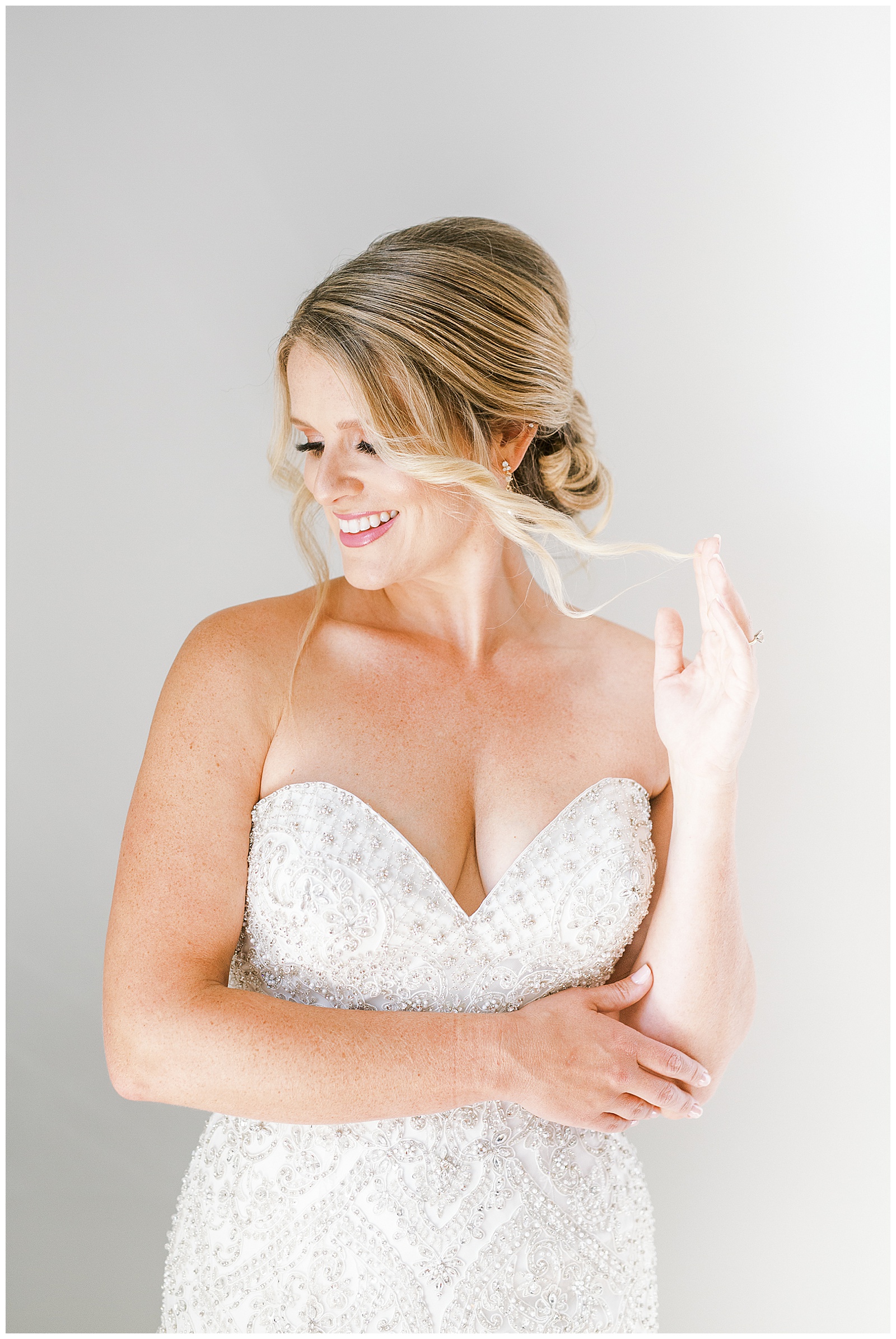 blonde haired bride twisted hair updo from gorgeous light and airy indoor bridal portraits