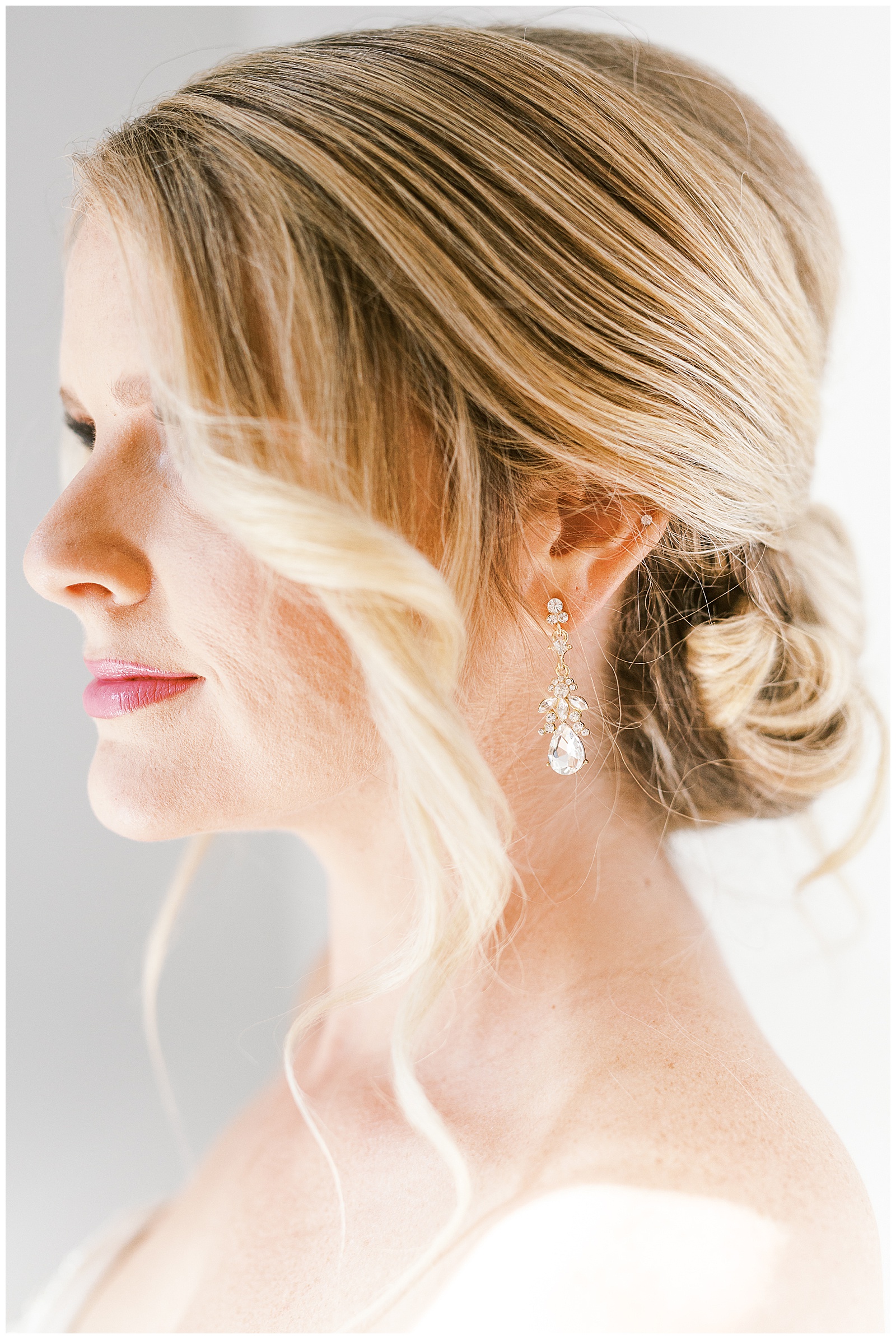 blonde haired bride twisted hair updo from gorgeous light and airy indoor bridal portraits
