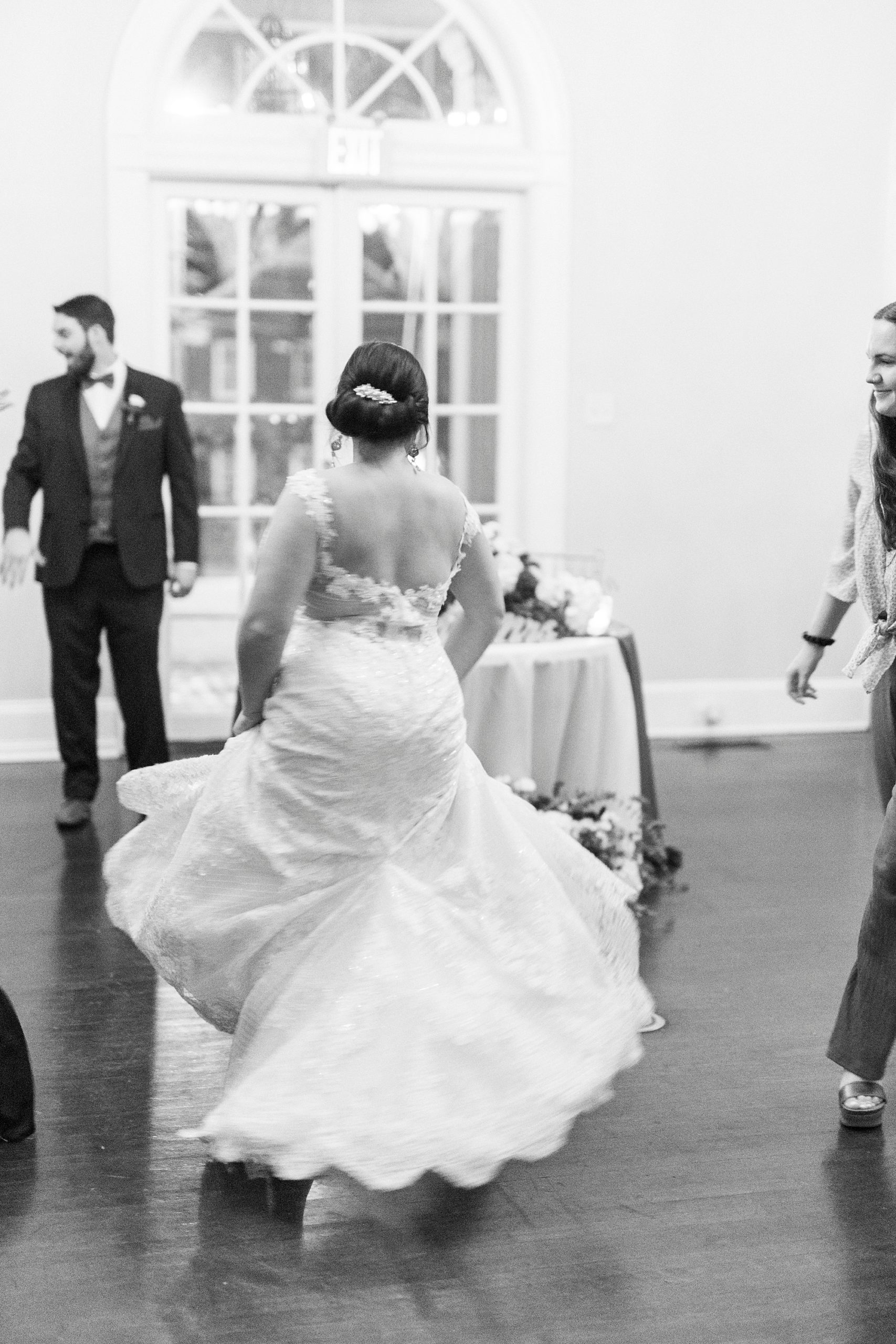 bride twirls wedding gown on dance floor