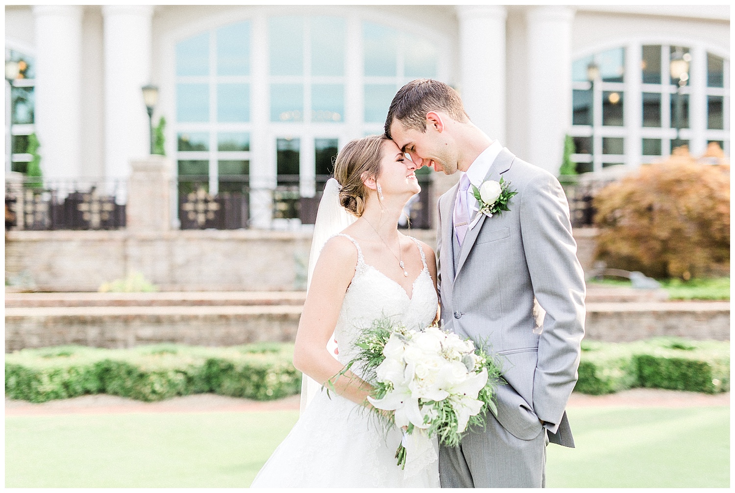 bride and groom outside grandover resort in greensboro nc for july wedding summer sun