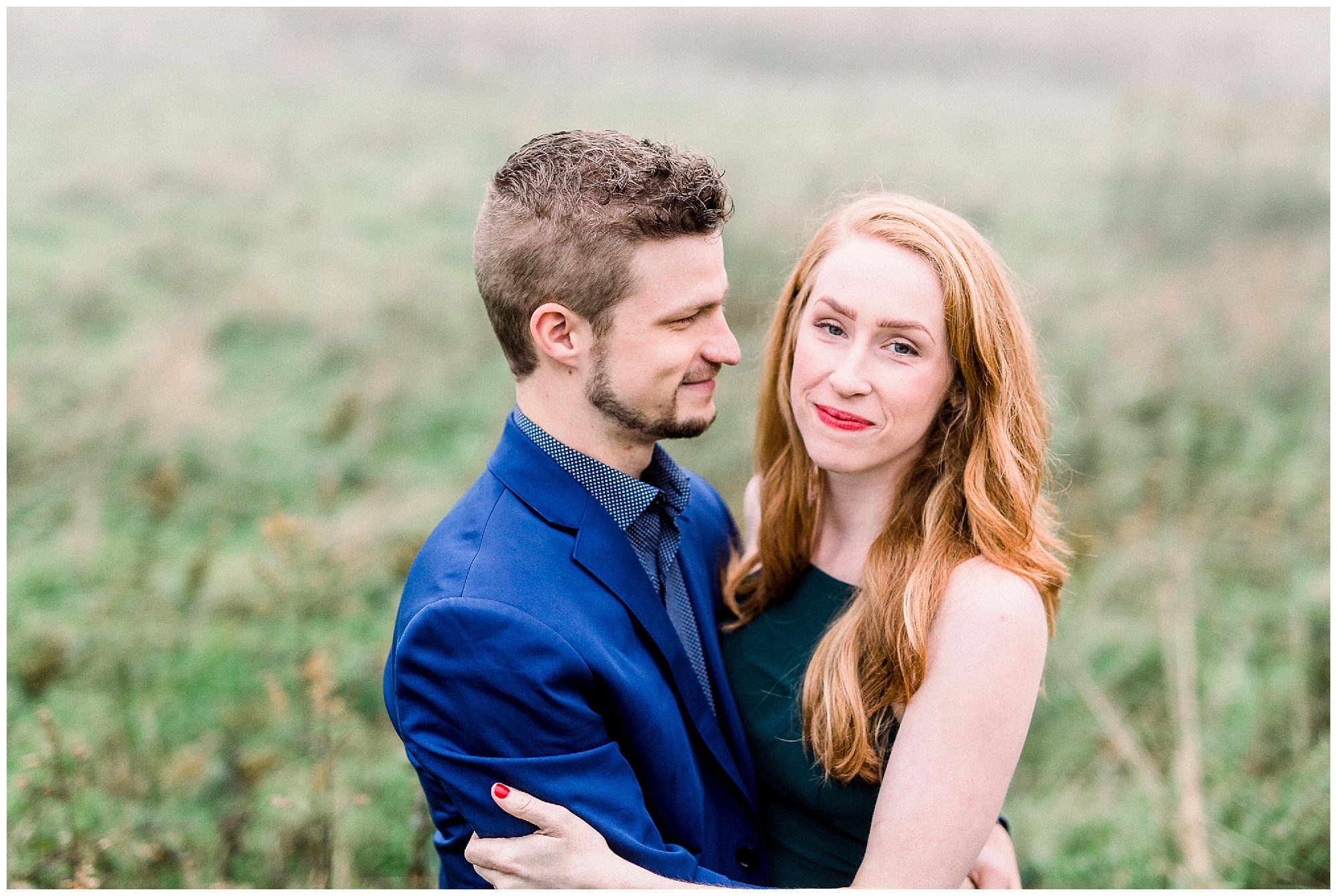 bride and groom hug along Blue Ridge Parkway during foggy mountain engagement session