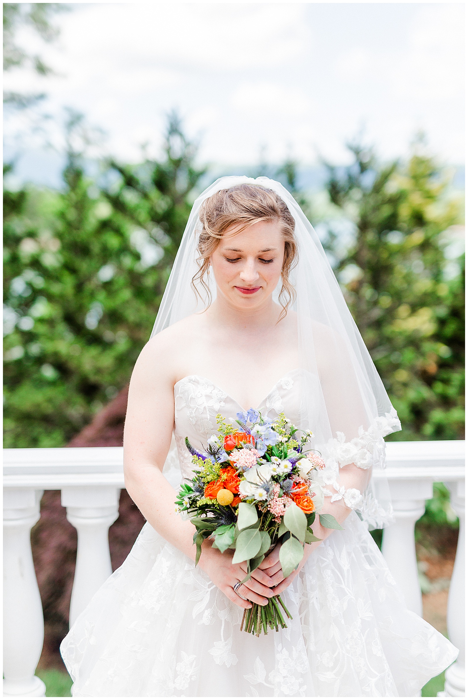 gorgeous scenic lakehouse white mansion location 👰 Bride: lace wedding dress + veil 💐 Colorful orange and blue bouquet 📸 Outdoorsy Lake and Mountain Bridal Session with Julia | Kevyn Dixon Photography