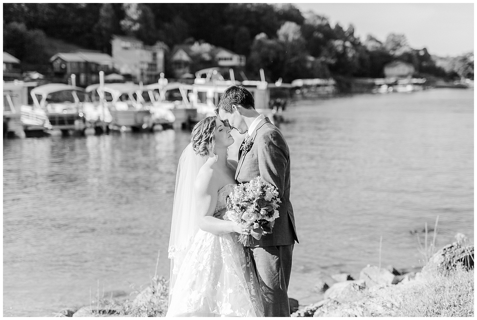 Bride and groom pause by the lake for photos from Outdoorsy Summer Wedding at North Carolina Lakehouse in the Mountains | check out the full wedding at KevynDixonPhoto.com