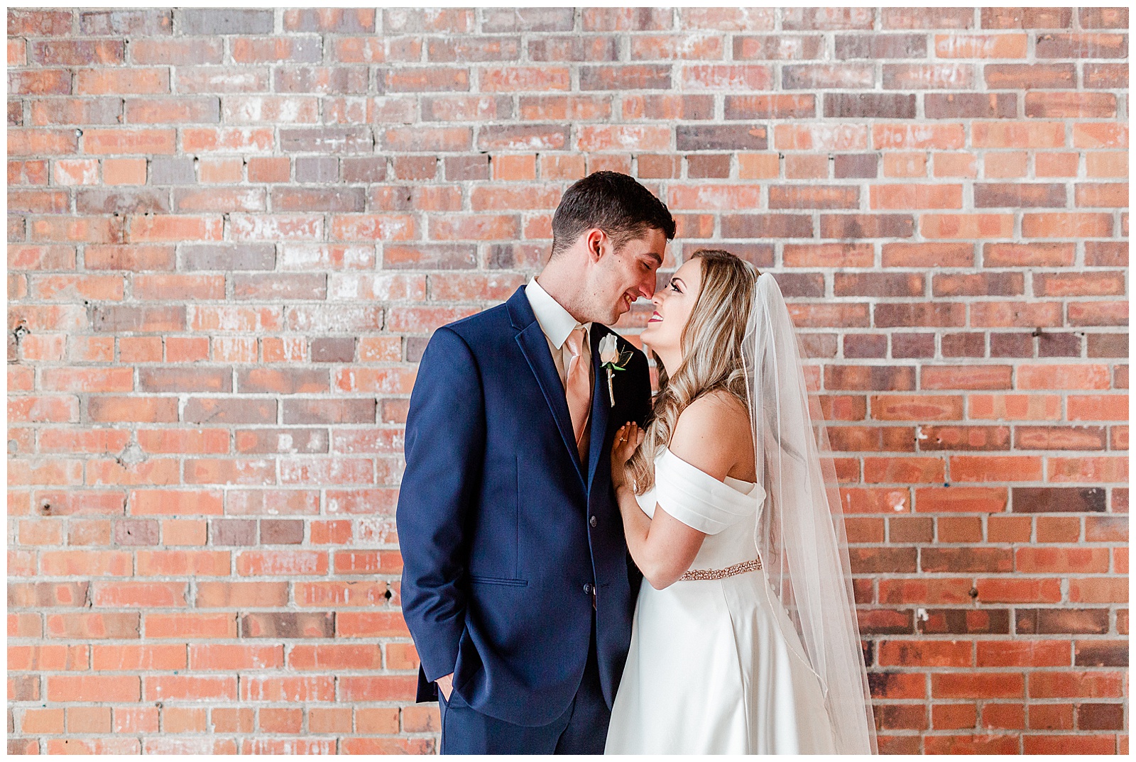 Adorable Bride and Groom Portraits against a red brick wall from Summer Wedding in Charlotte, NC | Check out the full wedding at KevynDixonPhoto.com