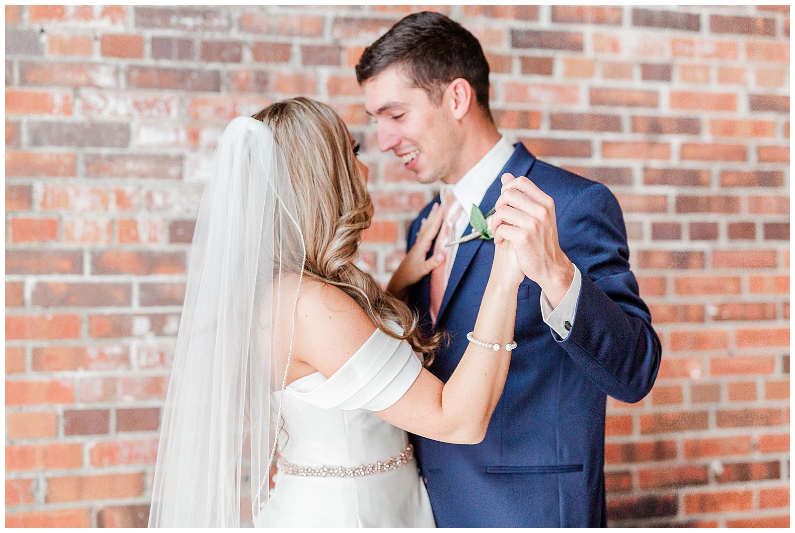 Adorable Bride and Groom Portraits against a red brick wall from Summer Wedding in Charlotte, NC | Check out the full wedding at KevynDixonPhoto.com