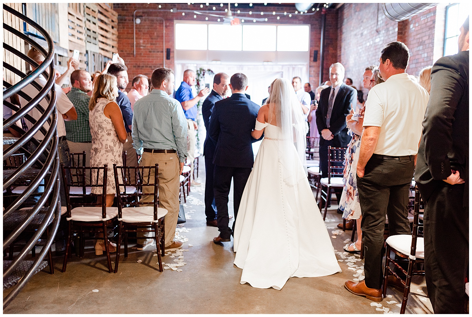 Dad walks bride down the aisle in stunning indoor venue with fairy lights in Charlotte, NC at Summer Wedding | Check out the full wedding at KevynDixonPhoto.com