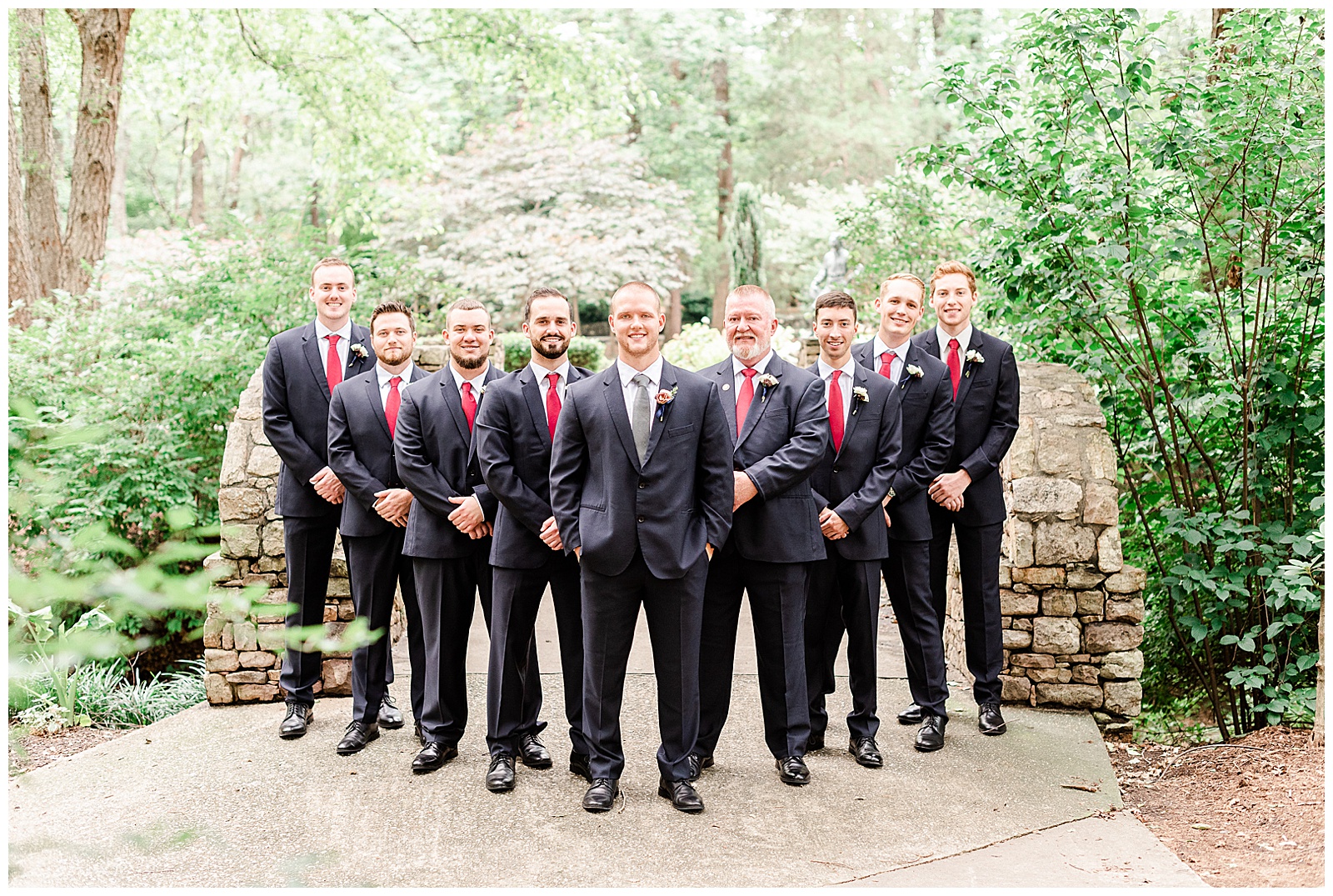 Dapper groomsmen in dark blue suits from Elegant Modern Red and Navy Blue Themed Wedding in Charlotte, NC | check out the full wedding at KevynDixonPhoto.com