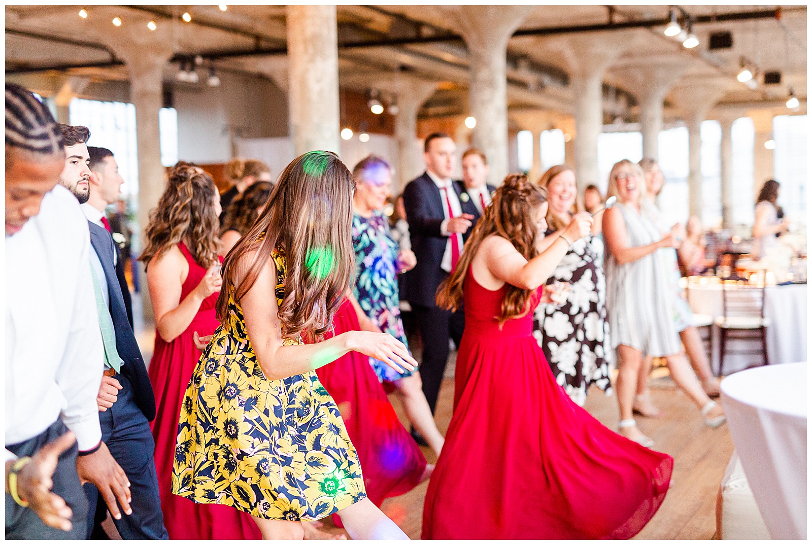 Join the dance party at Rustic Airy Indoor Wedding Venue with fairy lights - Red-Themed Bridesmaid Dress Ideas from Elegant Modern Summer Wedding in Charlotte, NC | check out the full wedding at KevynDixonPhoto.com