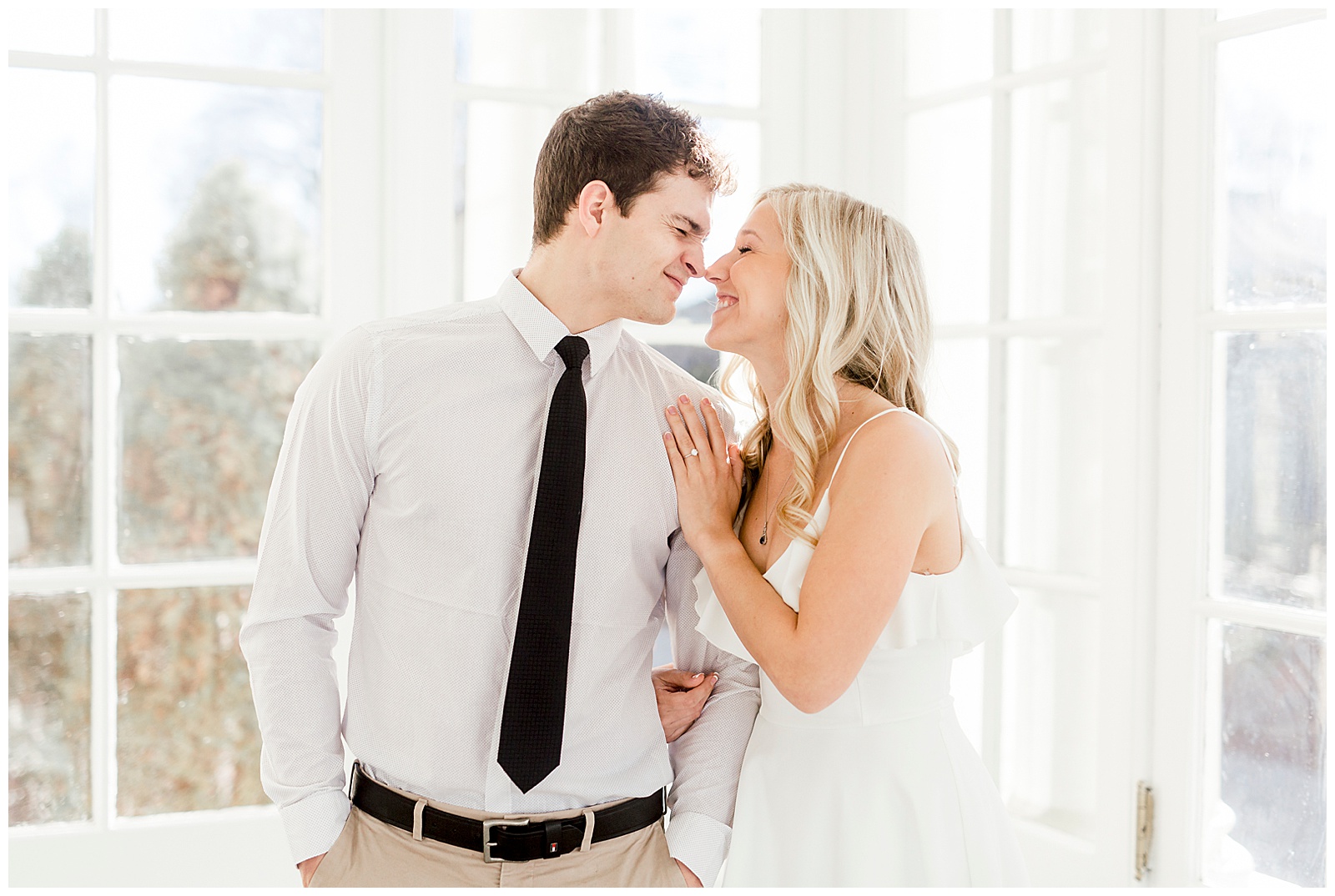 Adorable Couple Posing in Gorgeous Light and Airy Separk Mansion Engagement Session - classy black and white dress outfit ideas