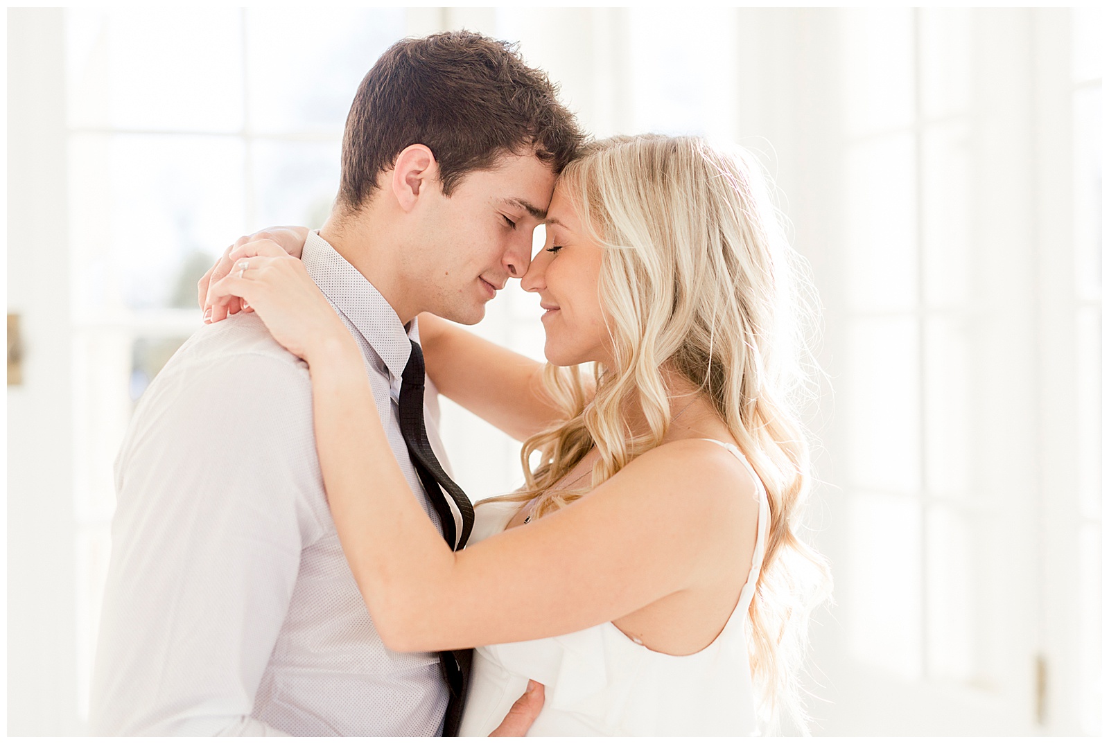 Adorable Couple Posing in Gorgeous Light and Airy Separk Mansion Engagement Session - classy black and white dress outfit ideas
