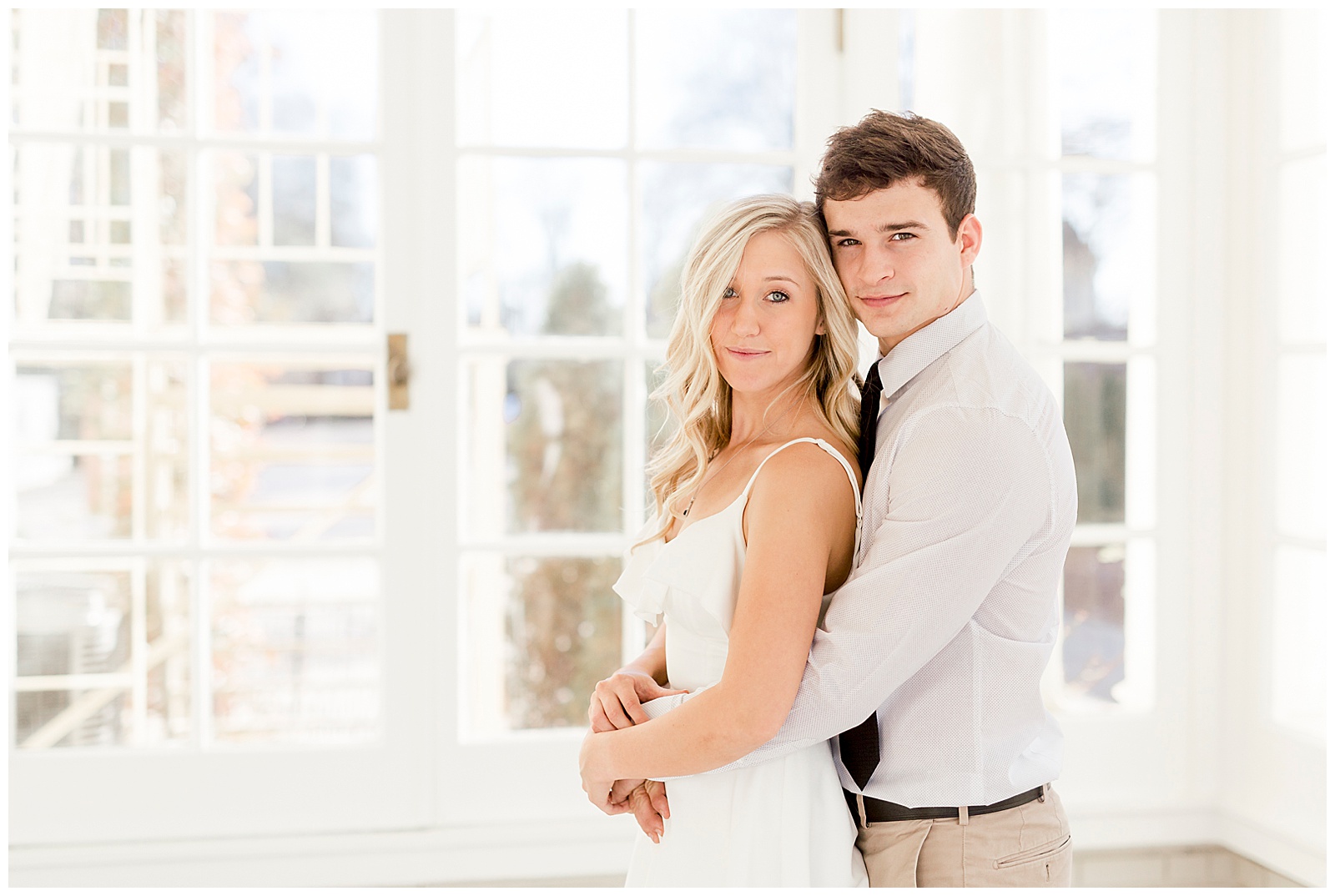 Adorable Couple Posing in Gorgeous Light and Airy Separk Mansion Engagement Session - classy black and white dress outfit ideas