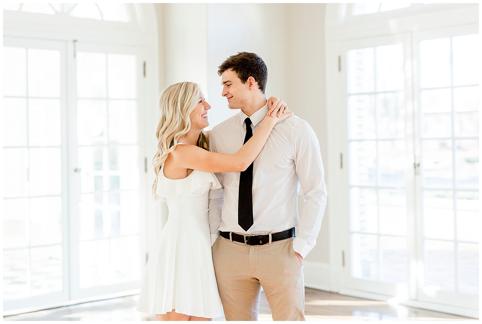 Adorable Couple Posing in Gorgeous Light and Airy Separk Mansion Engagement Session - classy black and white dress outfit ideas