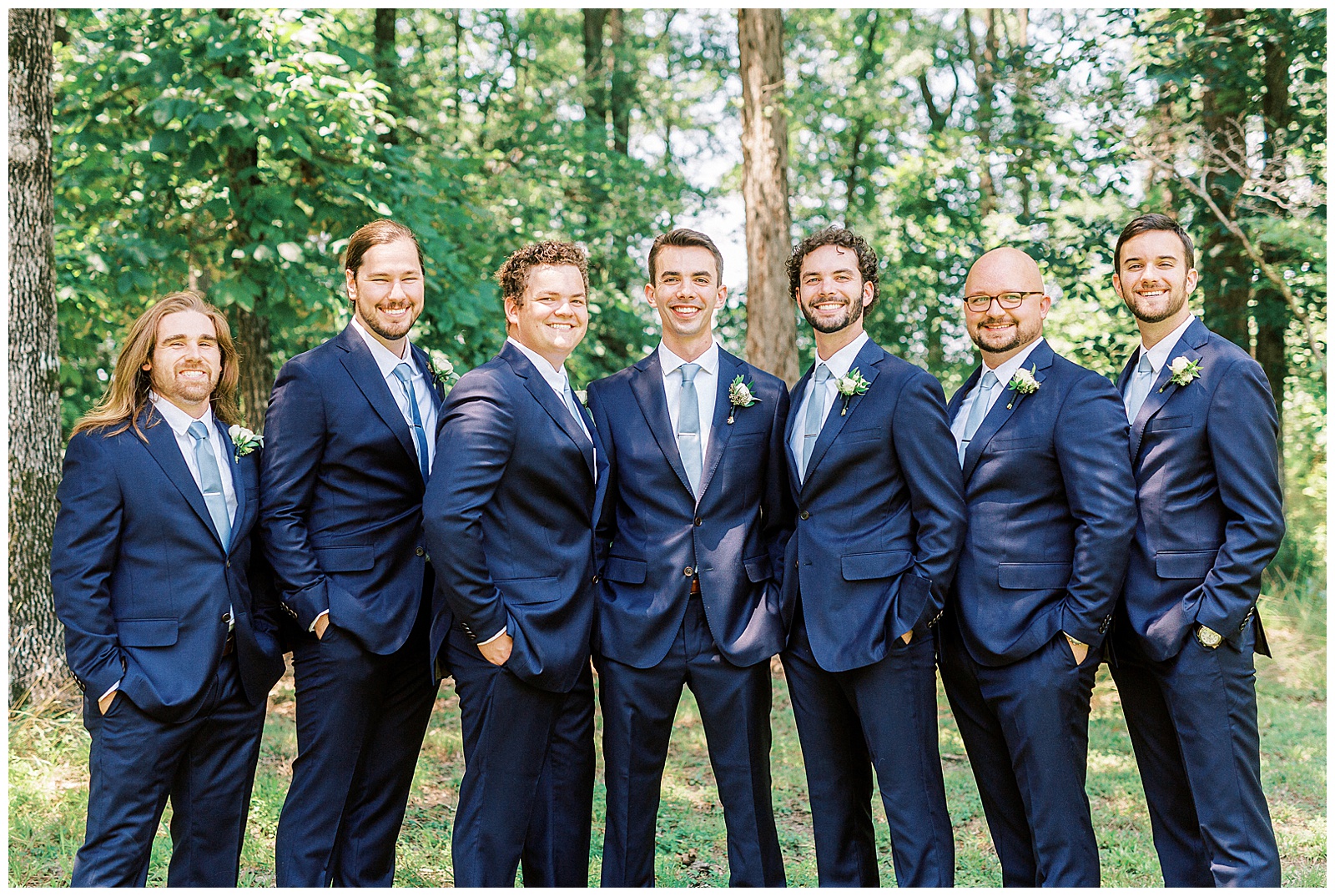 navy blue suits for groomsmen group photos laughing outdoors